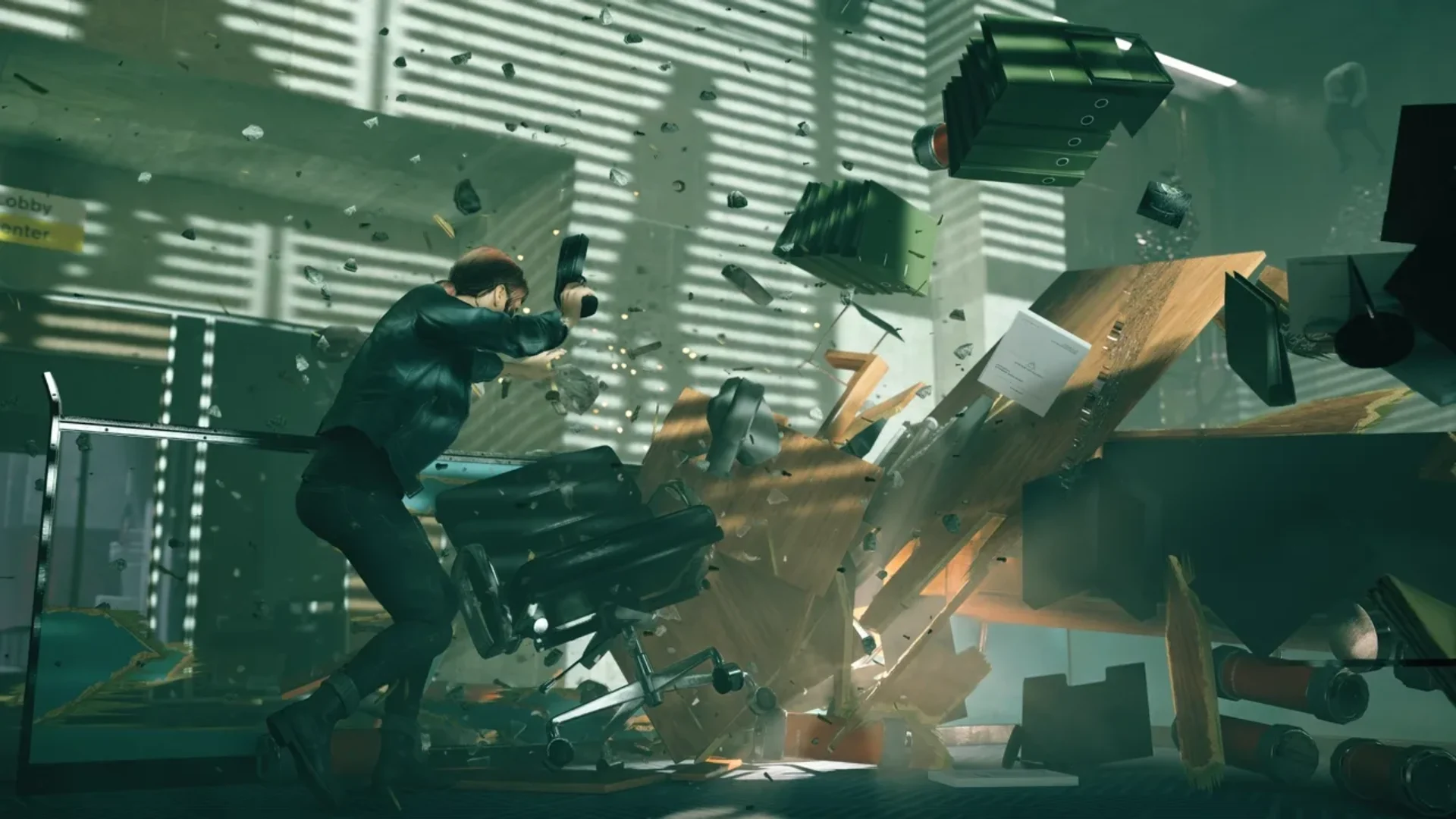 Jesse Faden uses her powers as office furniture and debris explode around her in Control.