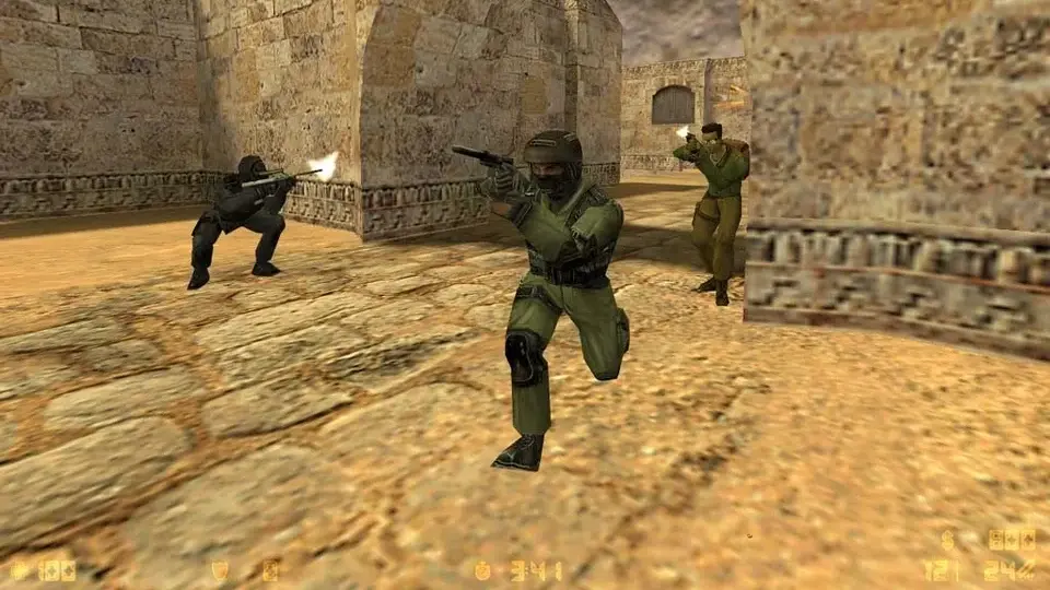 Counter-Strike gameplay showing armed players fighting on a desert map