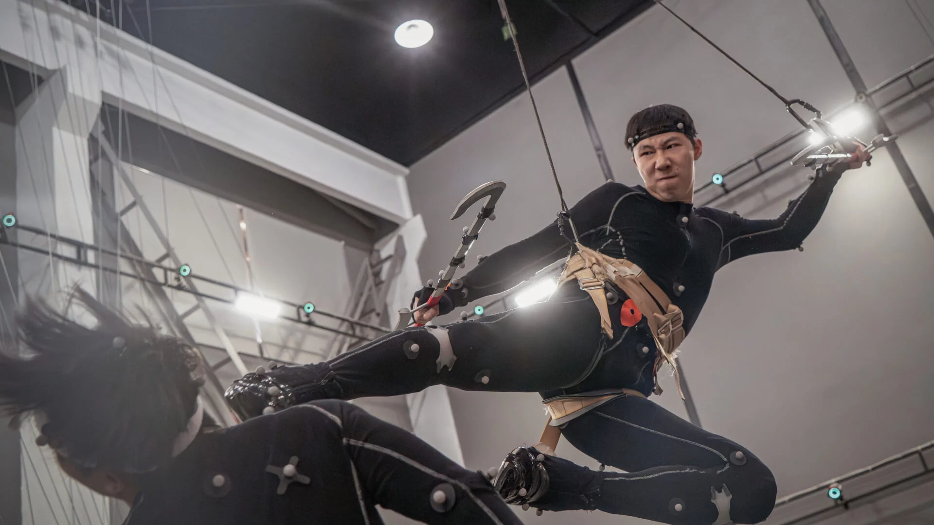 A motion capture performer executes a martial arts kick during production for Phantom Blade Zero.