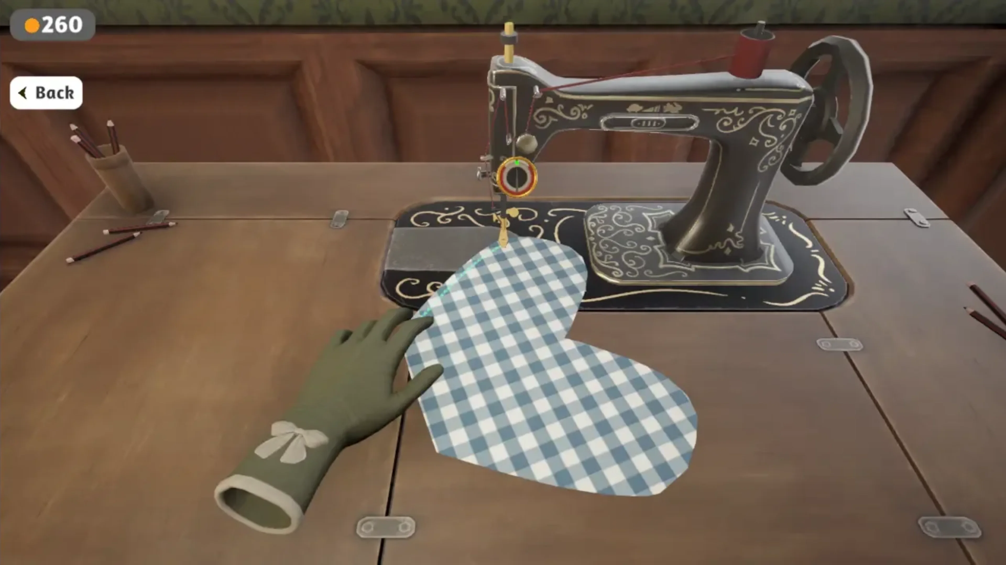 A gloved hand guides blue-and-white checkered fabric beneath a vintage black sewing machine in Dressmaker.