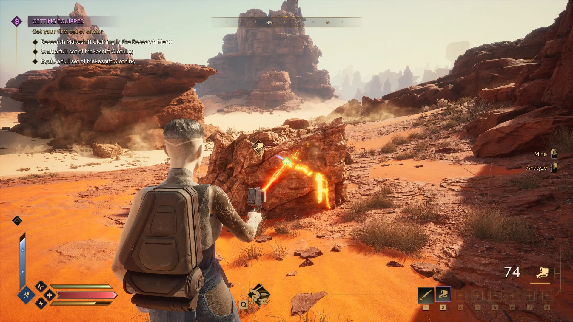 A Dune: Awakening player mines a glowing resource deposit among red desert rocks on Arrakis.