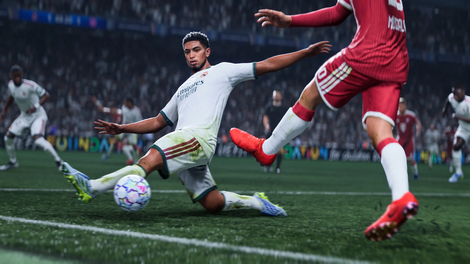 Real Madrid player slides toward the ball while challenging an opposing player during an EA Sports FC 27 match.