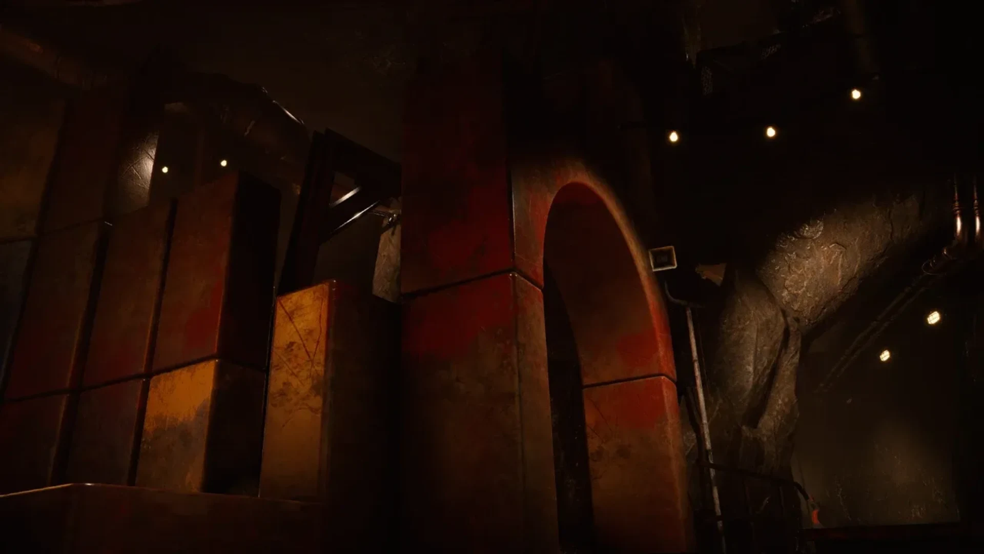 A dim industrial chamber with large metal structures, pipes, and orange lighting in Escape From Playtime.