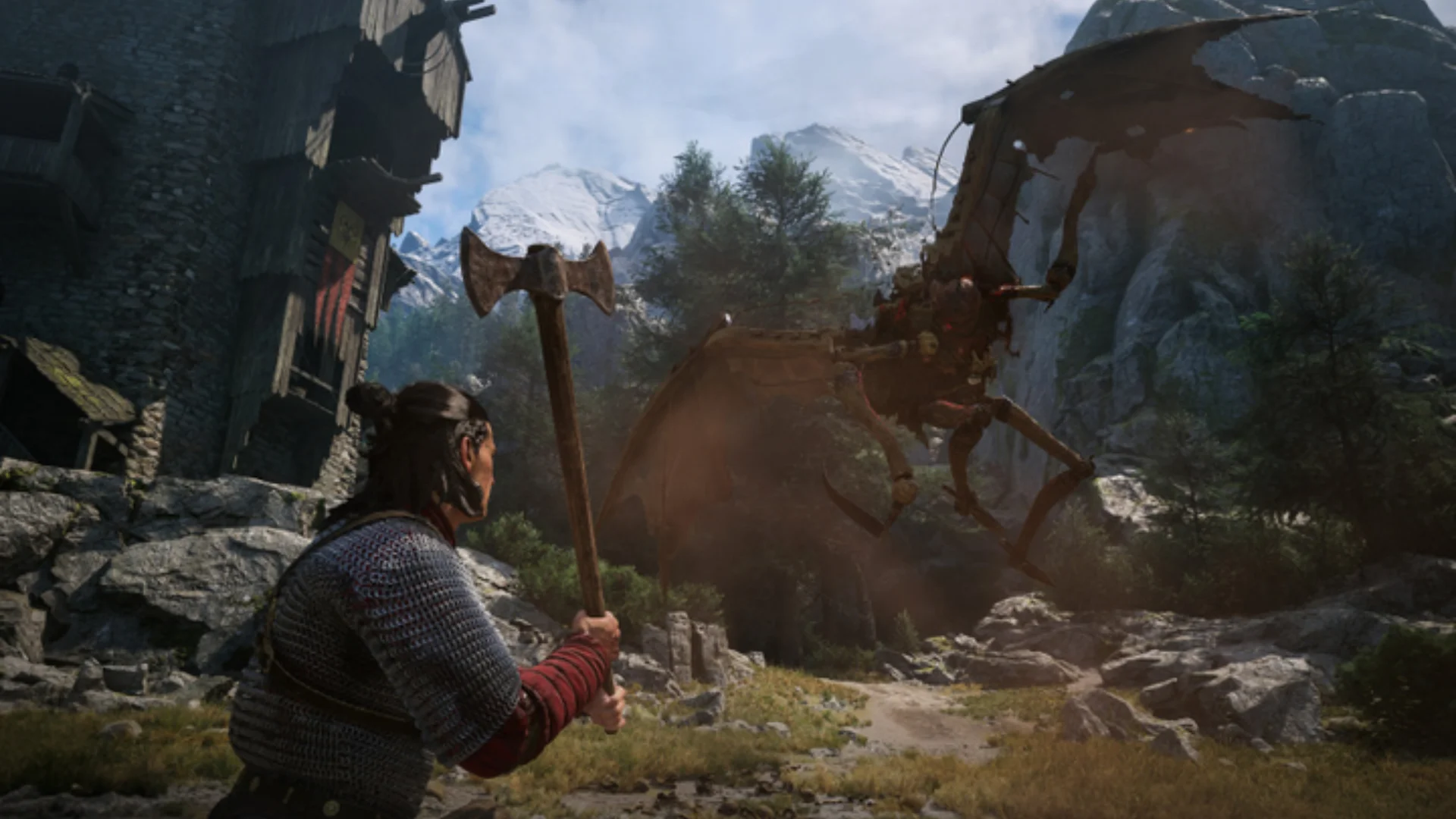 Coen holds an axe while facing a winged enemy in a mountainous settlement.