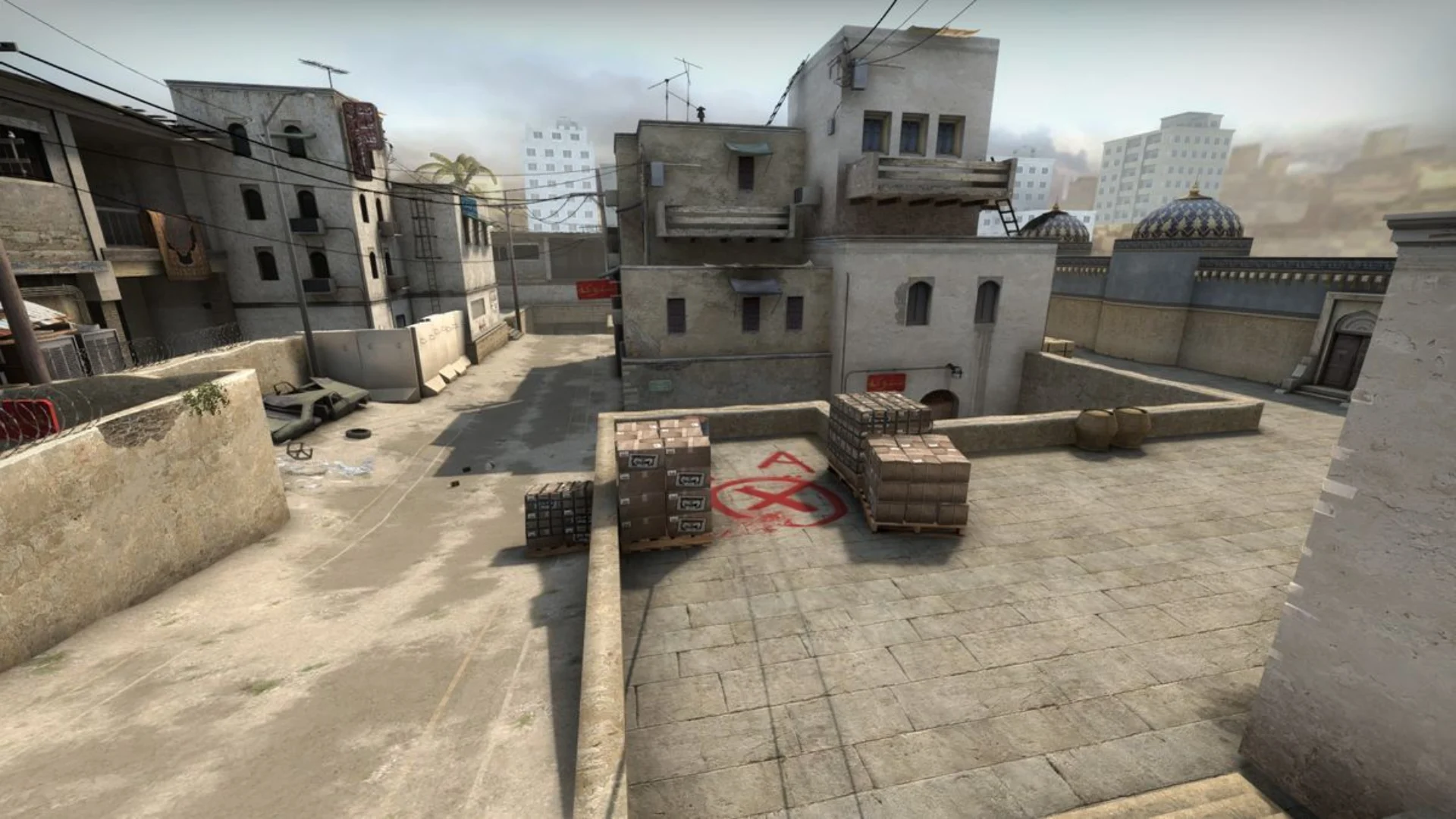 Counter-Strike map view showing the A bombsite with crates and surrounding buildings