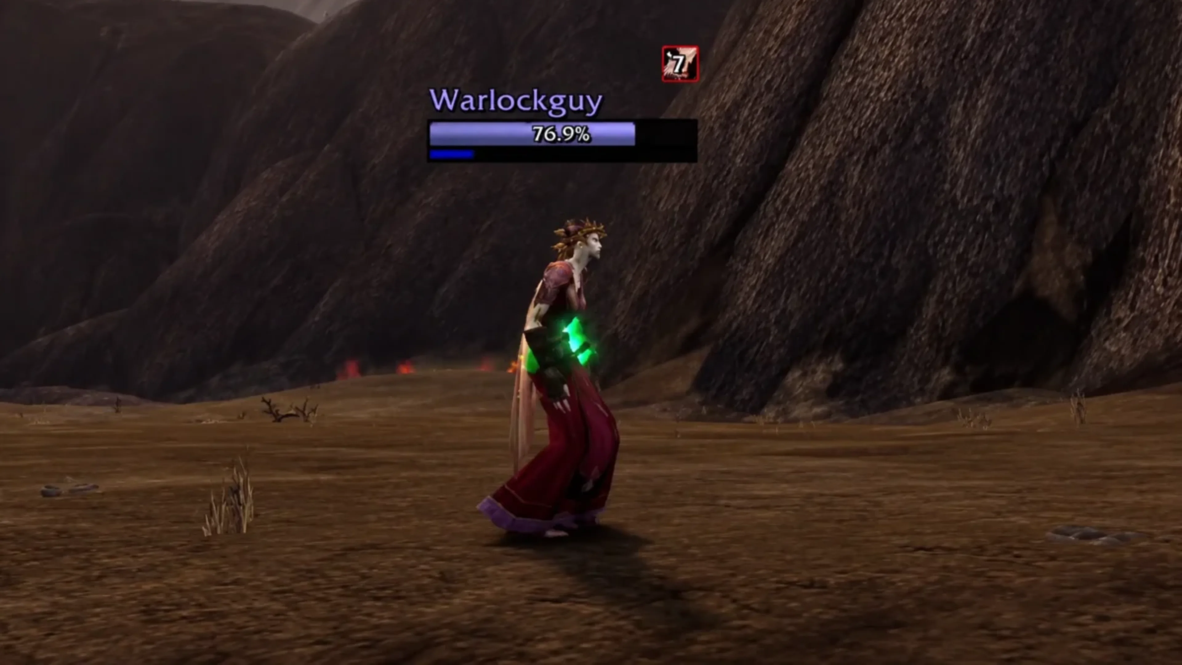Warlockguy's Undead Warlock character wearing red robes with glowing green hands in a rocky World of Warcraft: Forever arena.