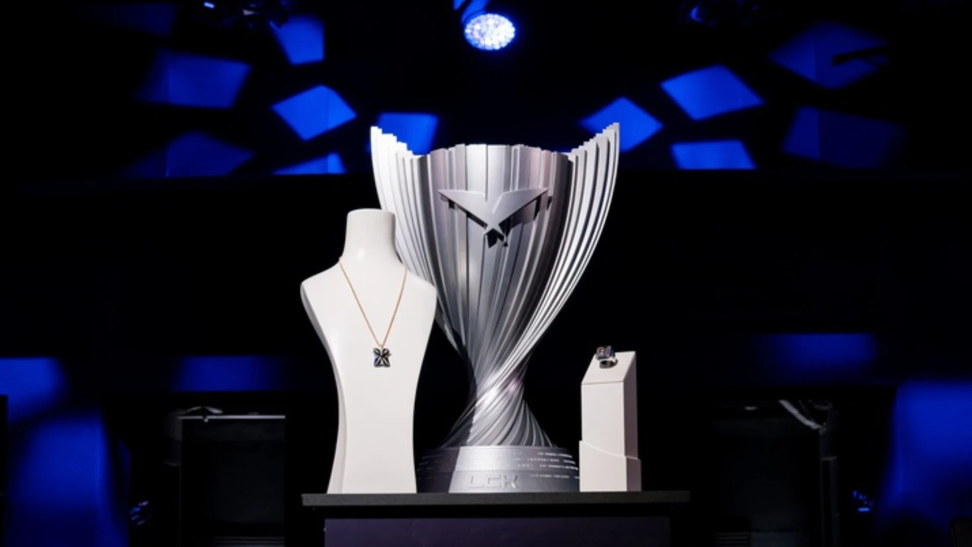 LCK championship trophy displayed on stage under blue lighting