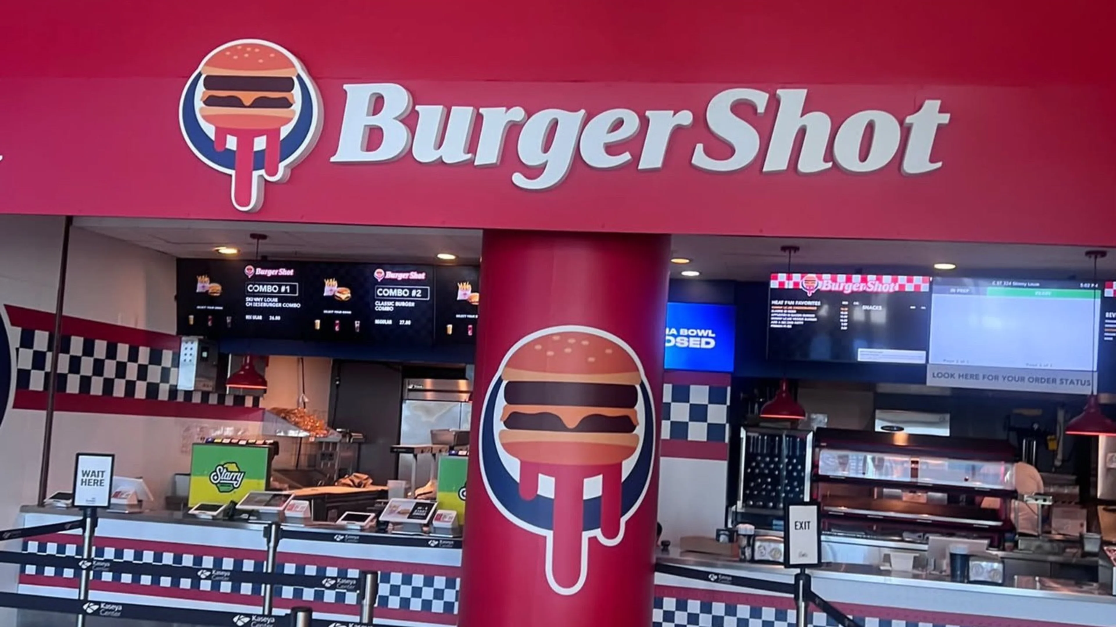 Burger Shot restaurant inside Miami's Kaseya Center featuring red branding, burger logos, ordering counters and digital menus.