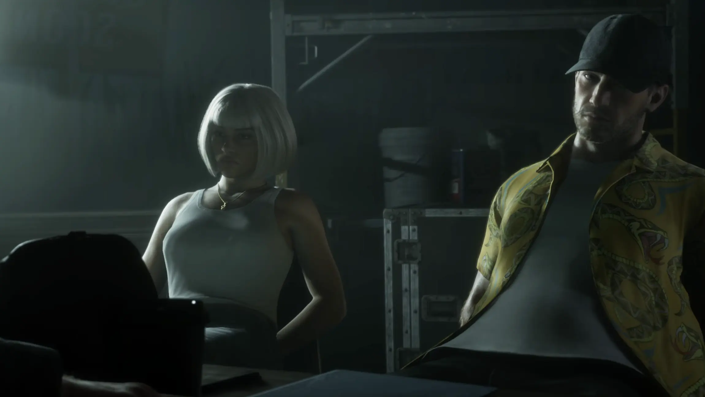 Lucia and Jason sit together during a dimly lit cutscene in GTA VI.
