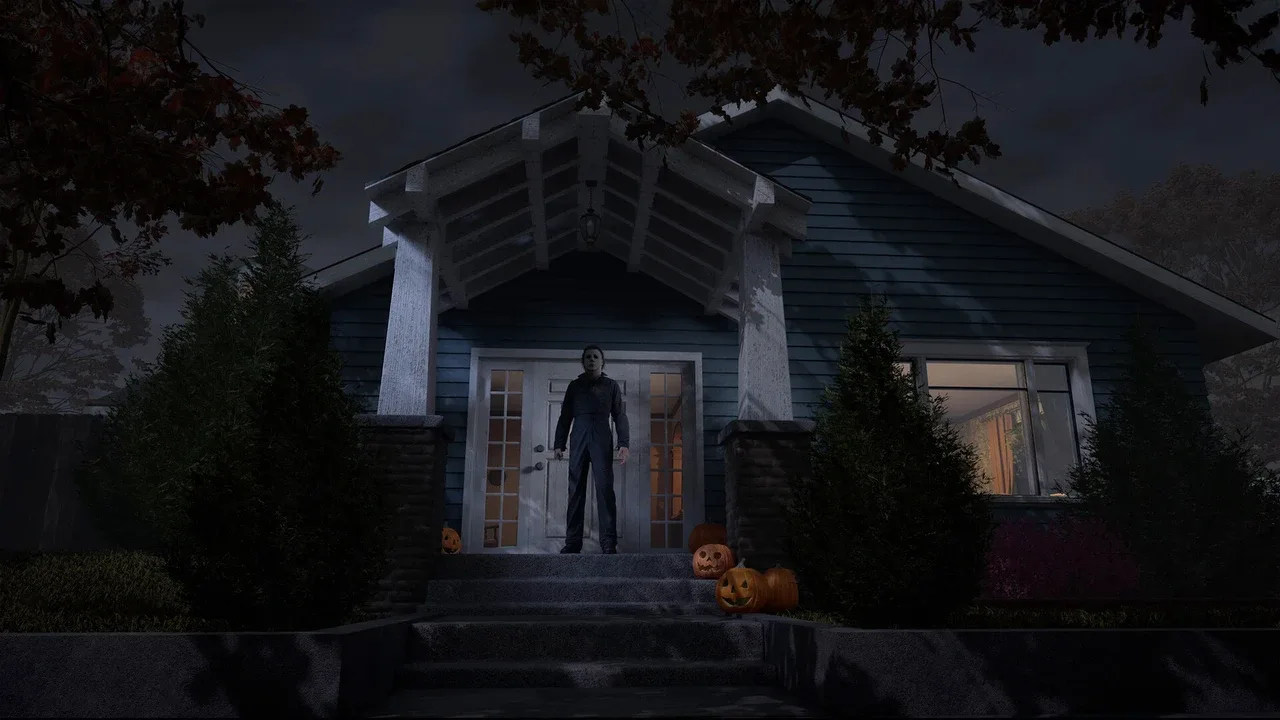 Michael Myers stands on the steps of a dark suburban house surrounded by Halloween pumpkins.