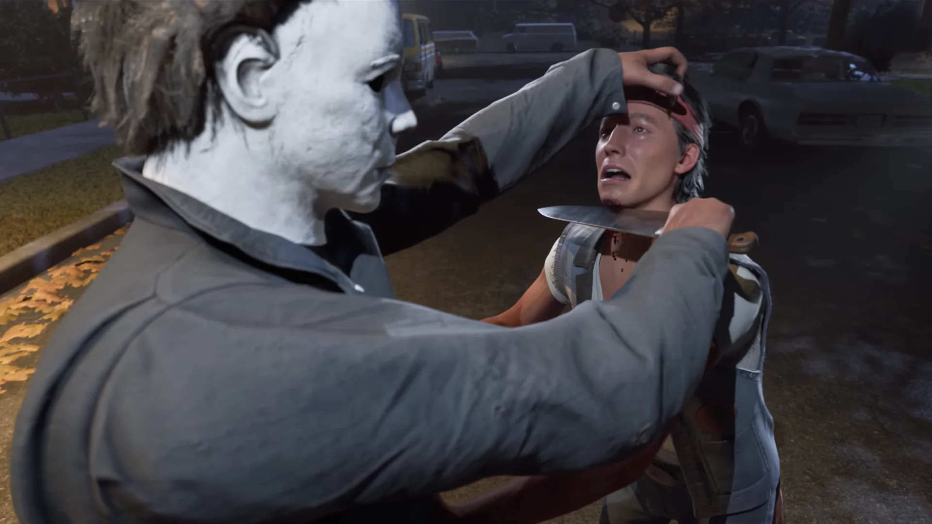 Michael Myers holds a knife to a frightened survivor during an attack in Halloween: The Game.