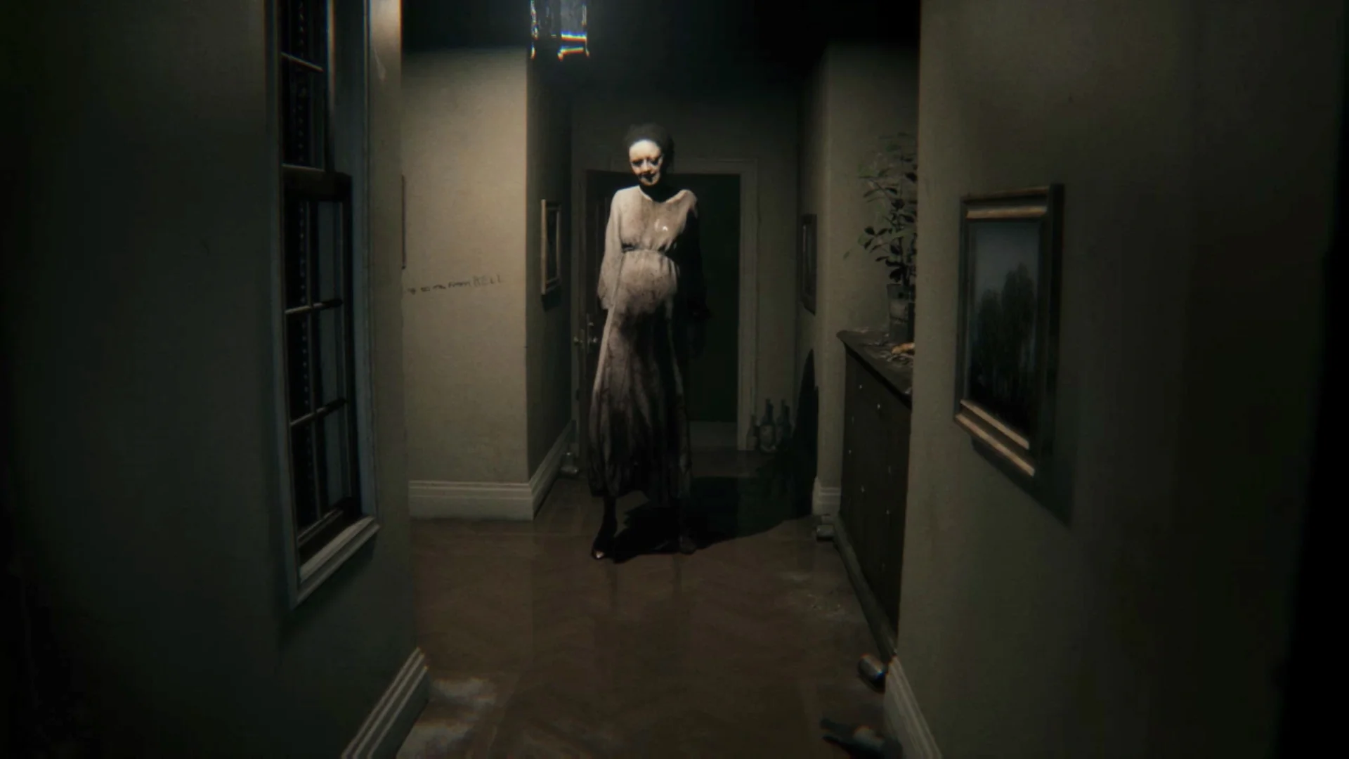 Lisa stands at the end of a dark hallway in the unofficial P.T. native PC port for Windows.