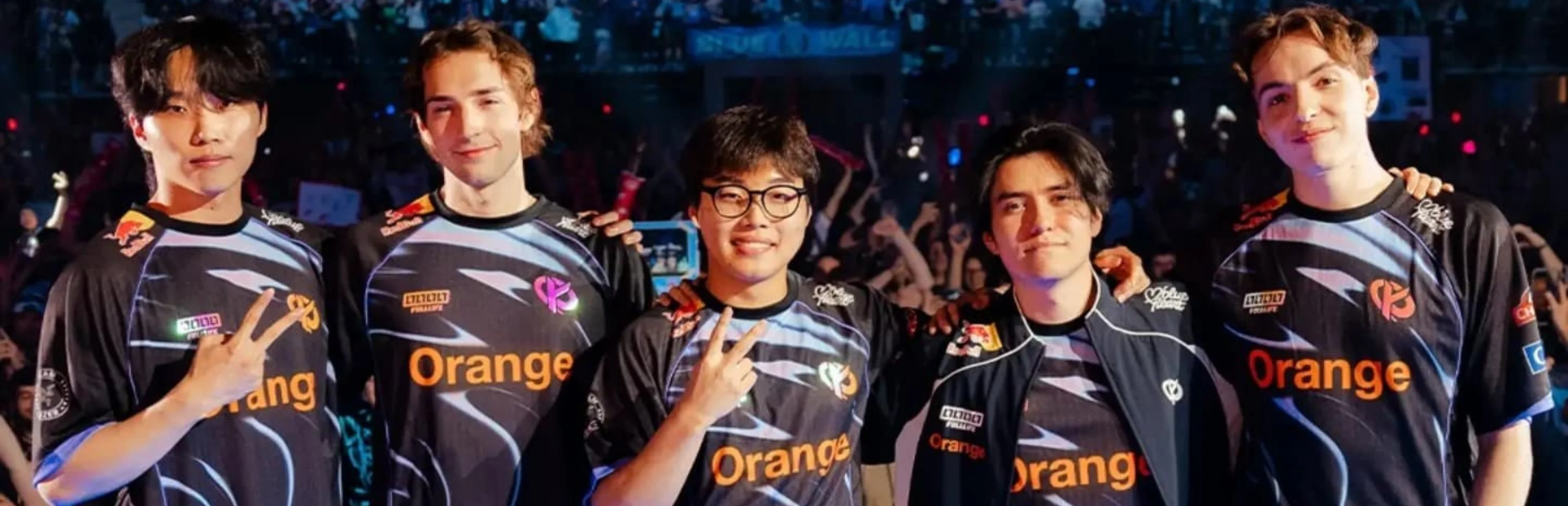 Five Karmine Corp League of Legends players pose together in black team jerseys in front of an esports audience.
