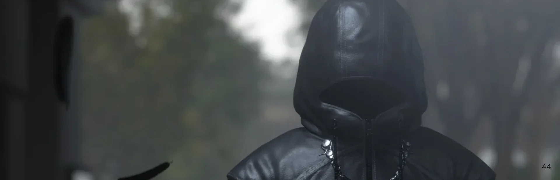 A hooded figure in black stands in a misty outdoor scene from the Kingdom Hearts IV D23 trailer.