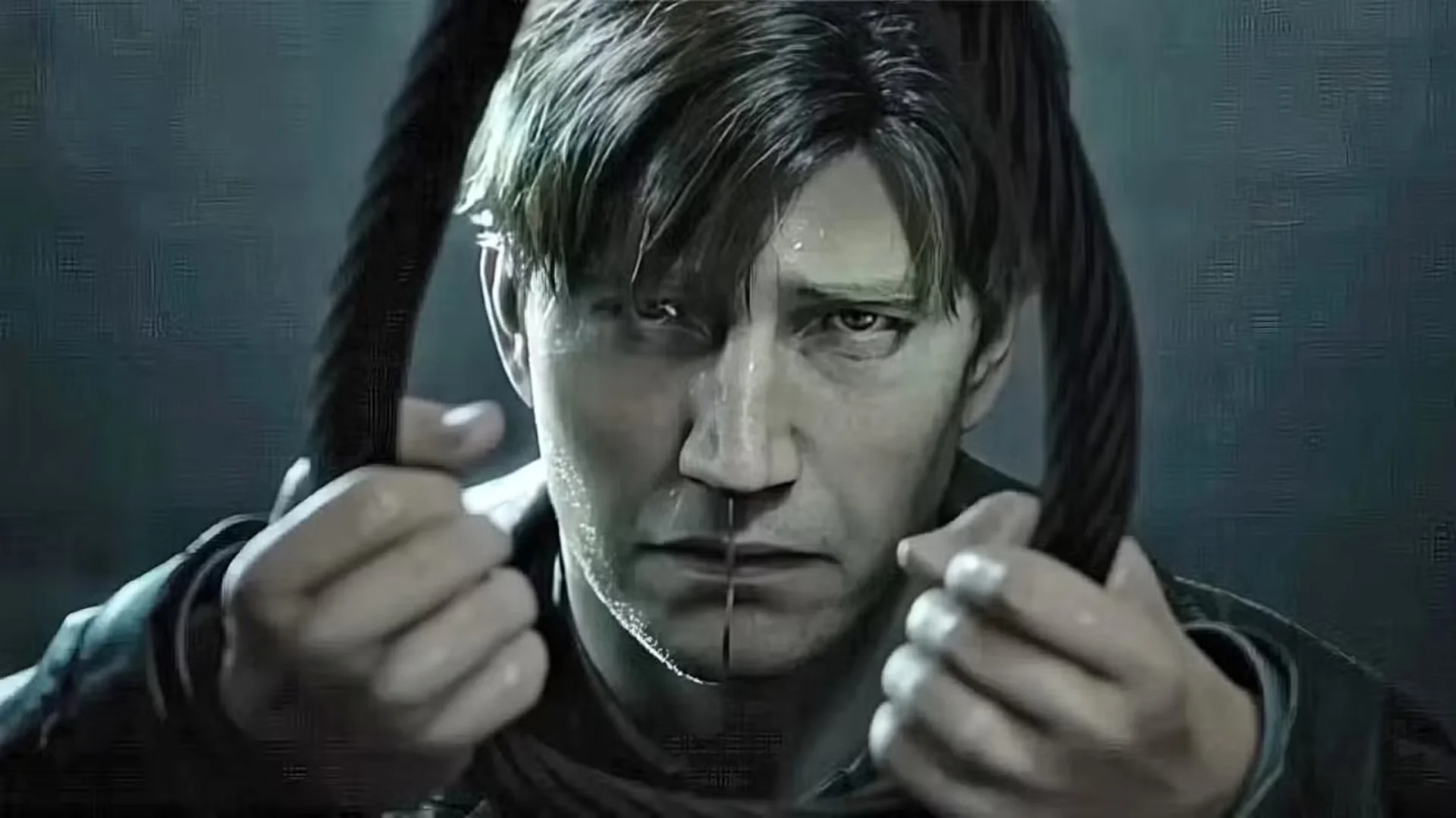 James Sunderland stares into a cracked mirror with his hands raised beside his face in Silent Hill 2.