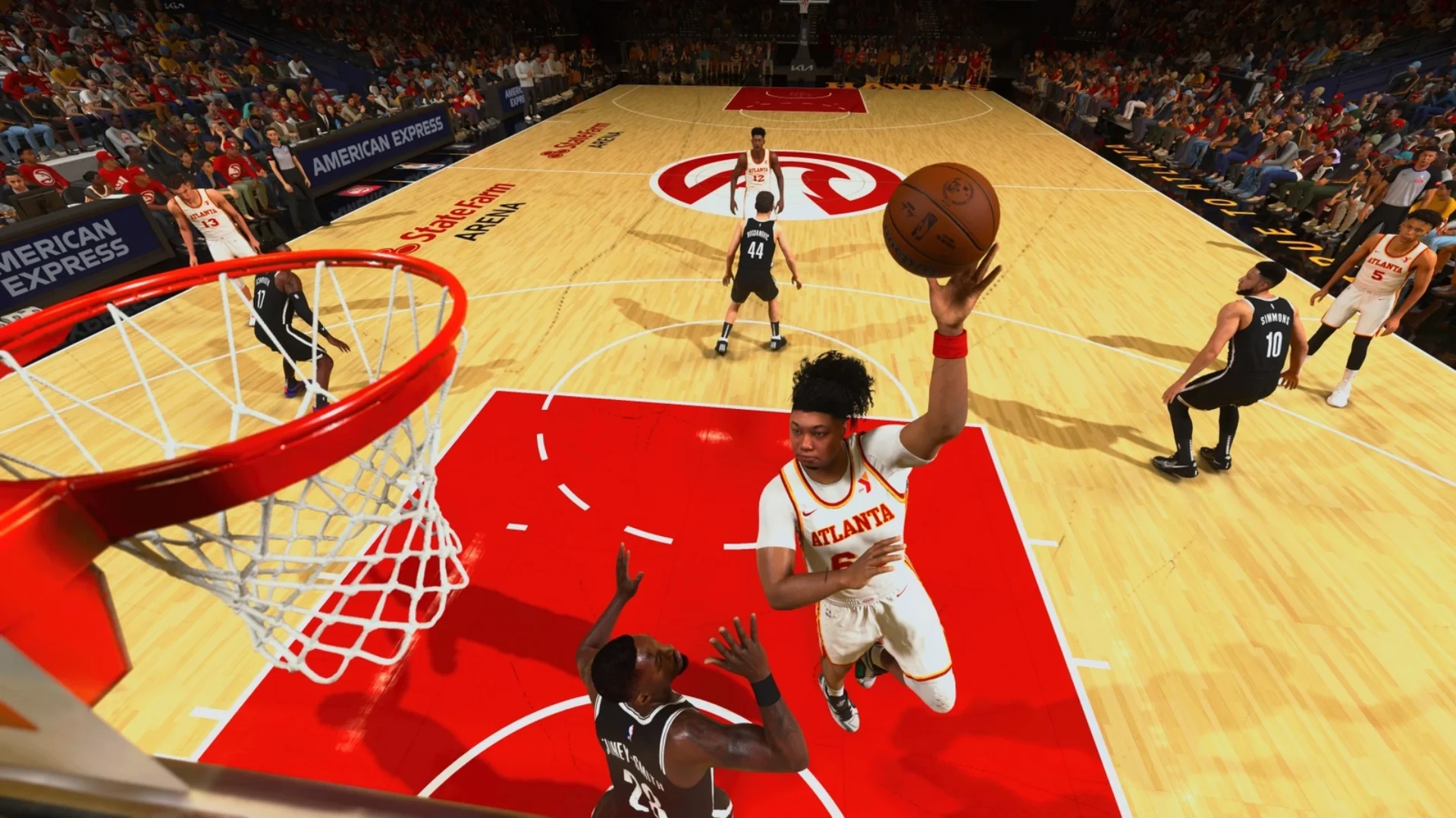 An Atlanta Hawks player goes up for a one-handed dunk against a defender in NBA 2K25.