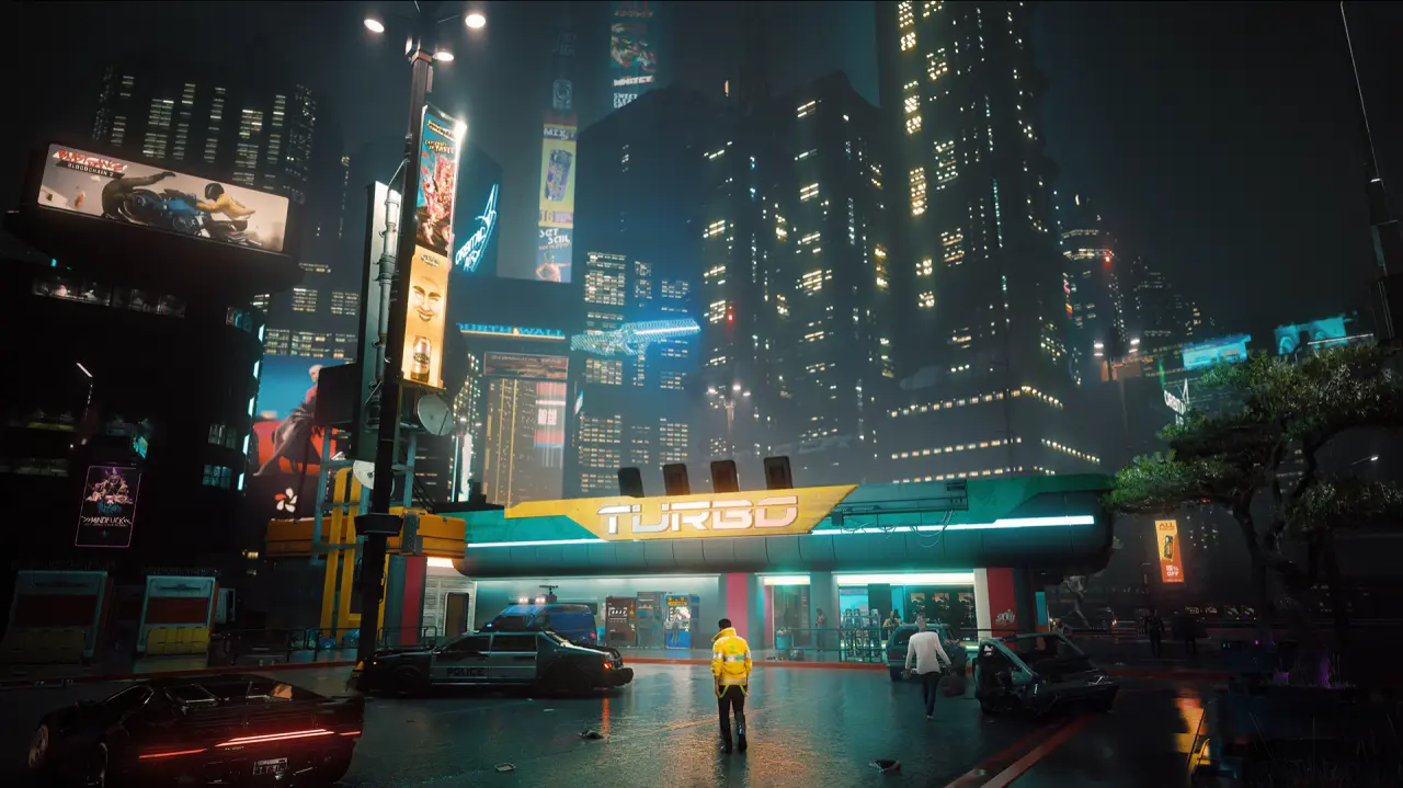 A rain-soaked street and brightly illuminated skyscrapers in Night City from Cyberpunk 2077.