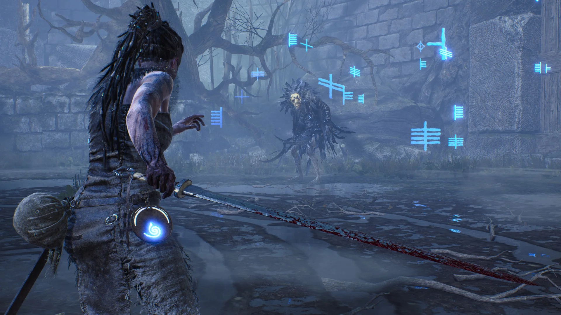 Senua holds a bloodied sword while facing a creature surrounded by glowing blue symbols in ruined wetlands.