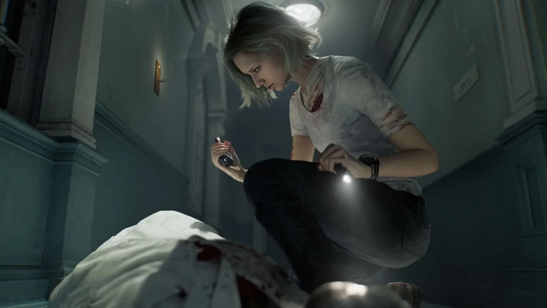 Grace Ashcroft crouches beside a body while holding a flashlight in a dark hallway in Resident Evil Requiem.