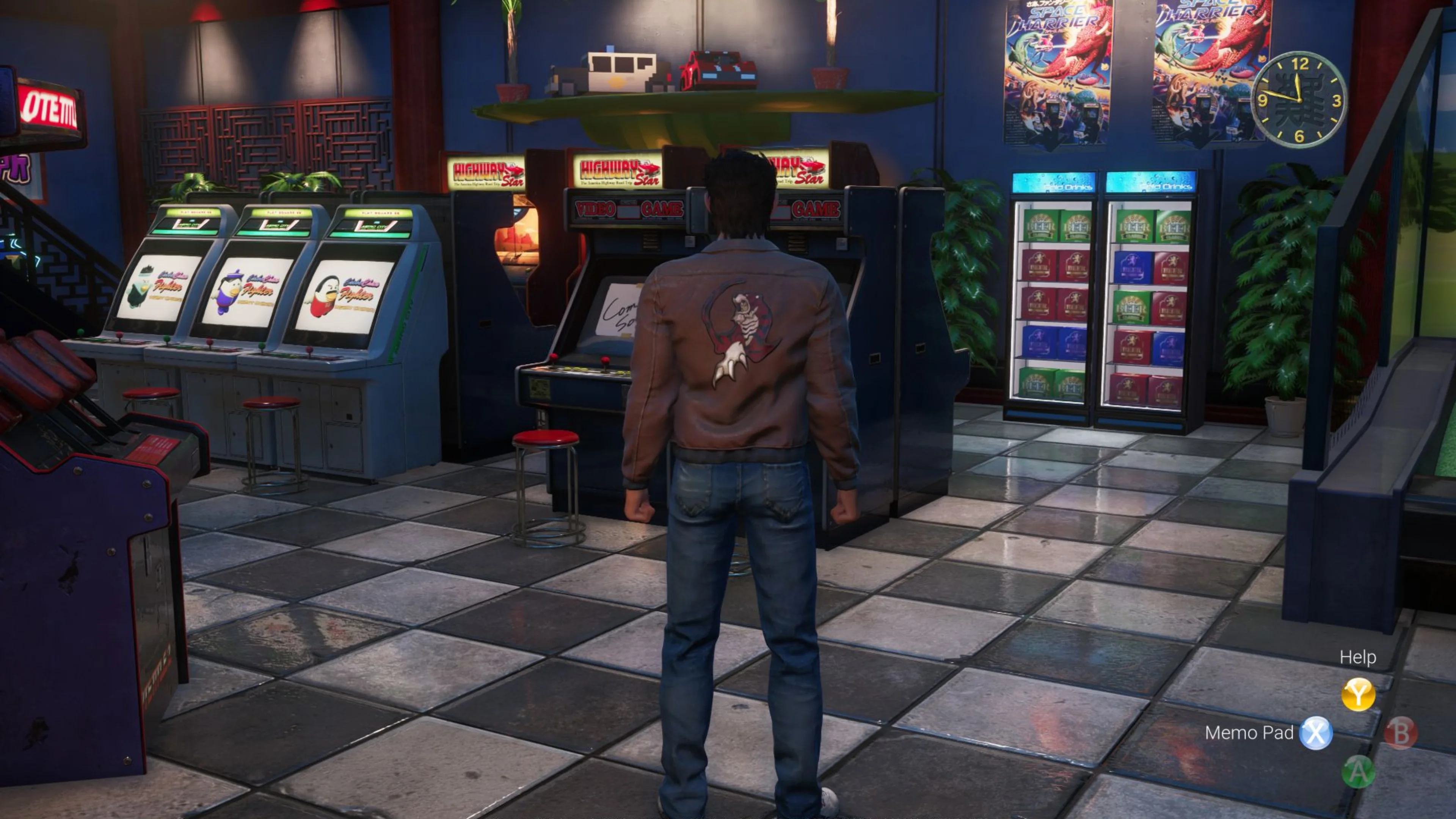 Ryo Hazuki stands inside an arcade filled with video game cabinets, stools, colorful posters and prize machines in Shenmue III.