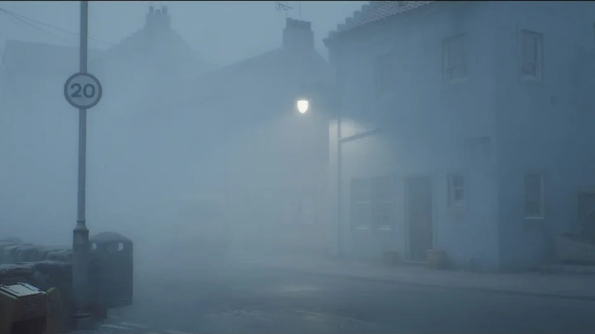 Dense fog covers an empty residential street illuminated by a streetlamp in Silent Hill: Townfall.