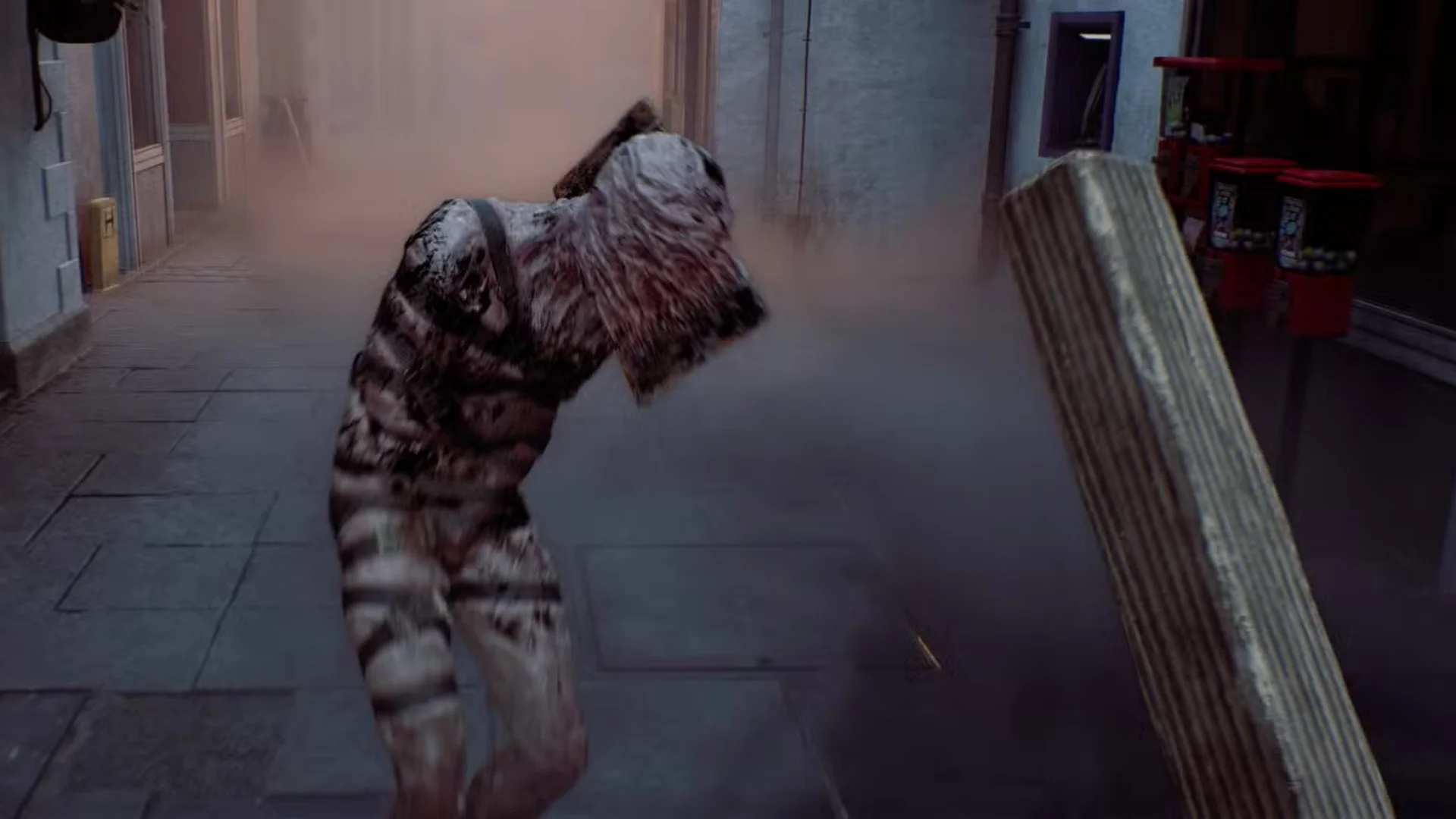 The Weight swings at the player at close range inside a fog-filled building in Silent Hill: Townfall.