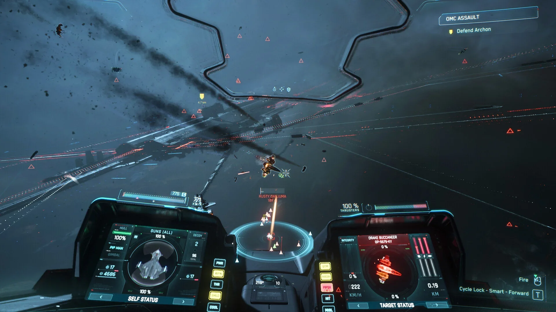 Squadron 42 cockpit view shows a space battle with distant ships, red laser fire and illuminated targeting displays.