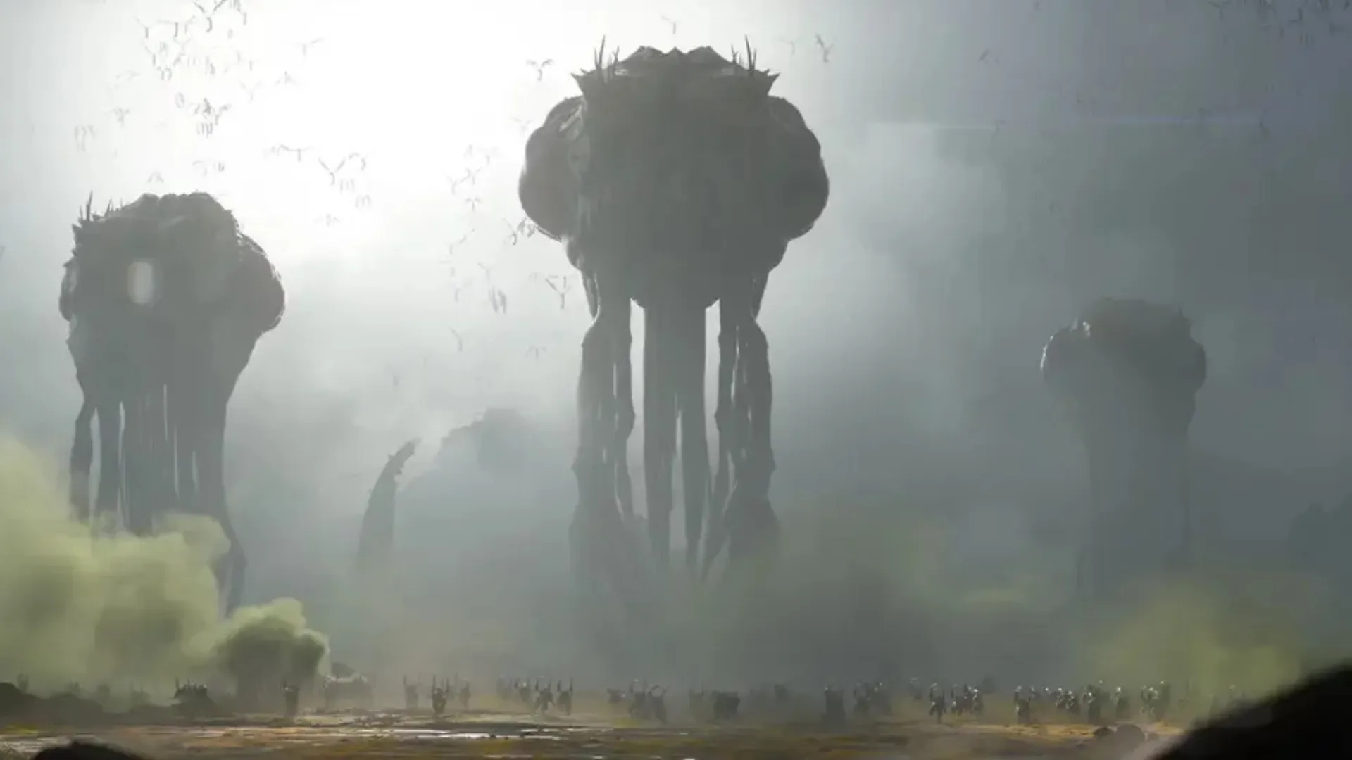 Three towering alien creatures stand above soldiers in a foggy STARCRAFT battlefield