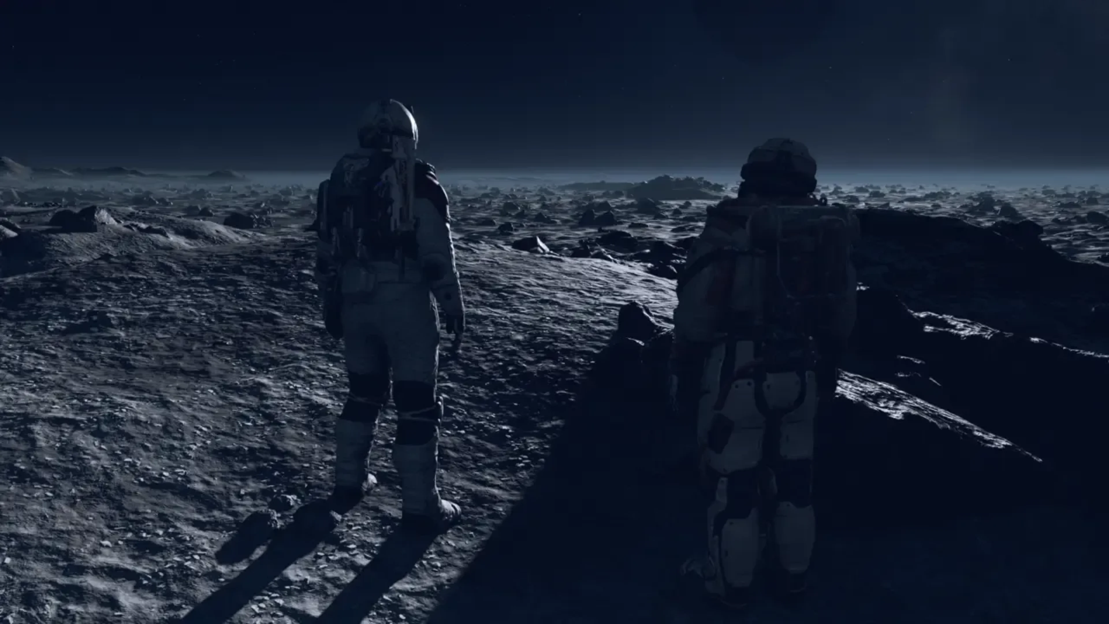 Two Starfield astronauts standing on a dark, rocky planetary surface beneath a night sky.