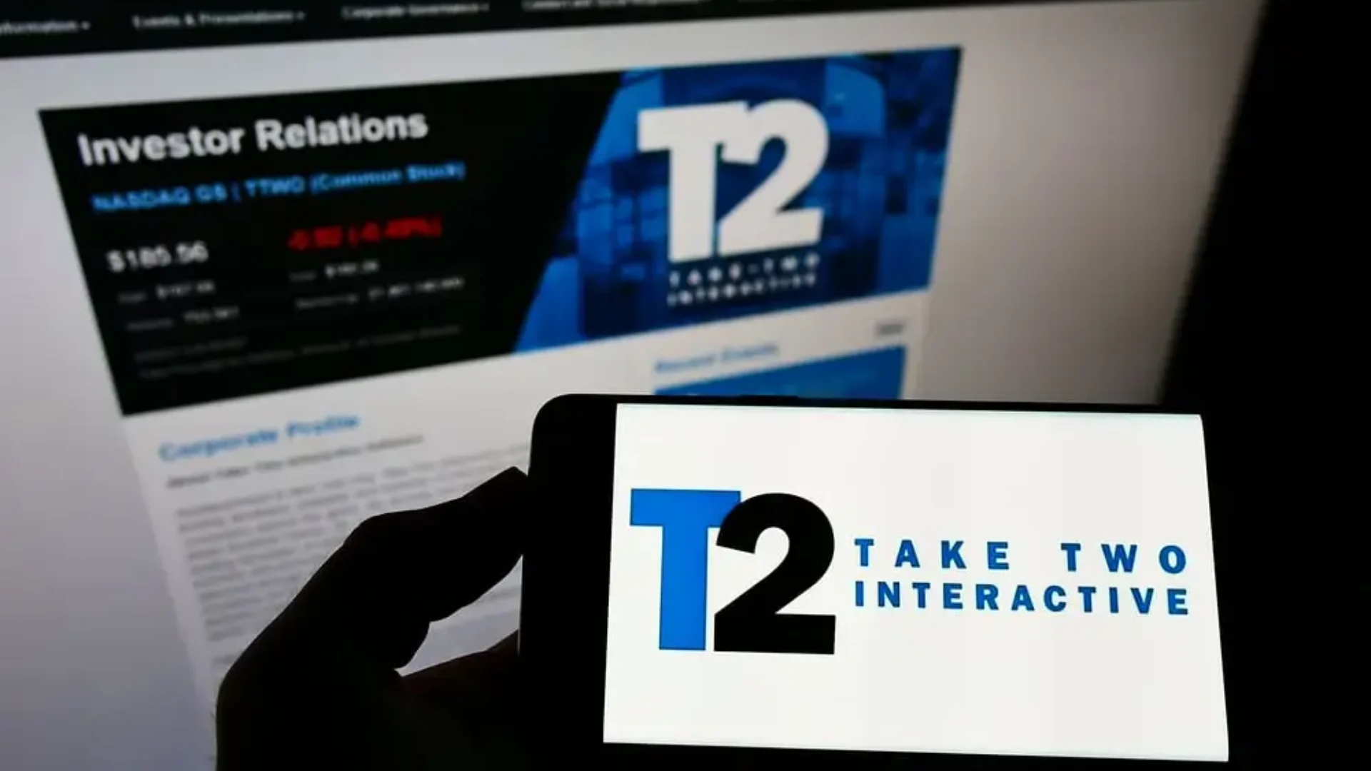 Take-Two Interactive logo displayed on a smartphone in front of the company's Investor Relations webpage.