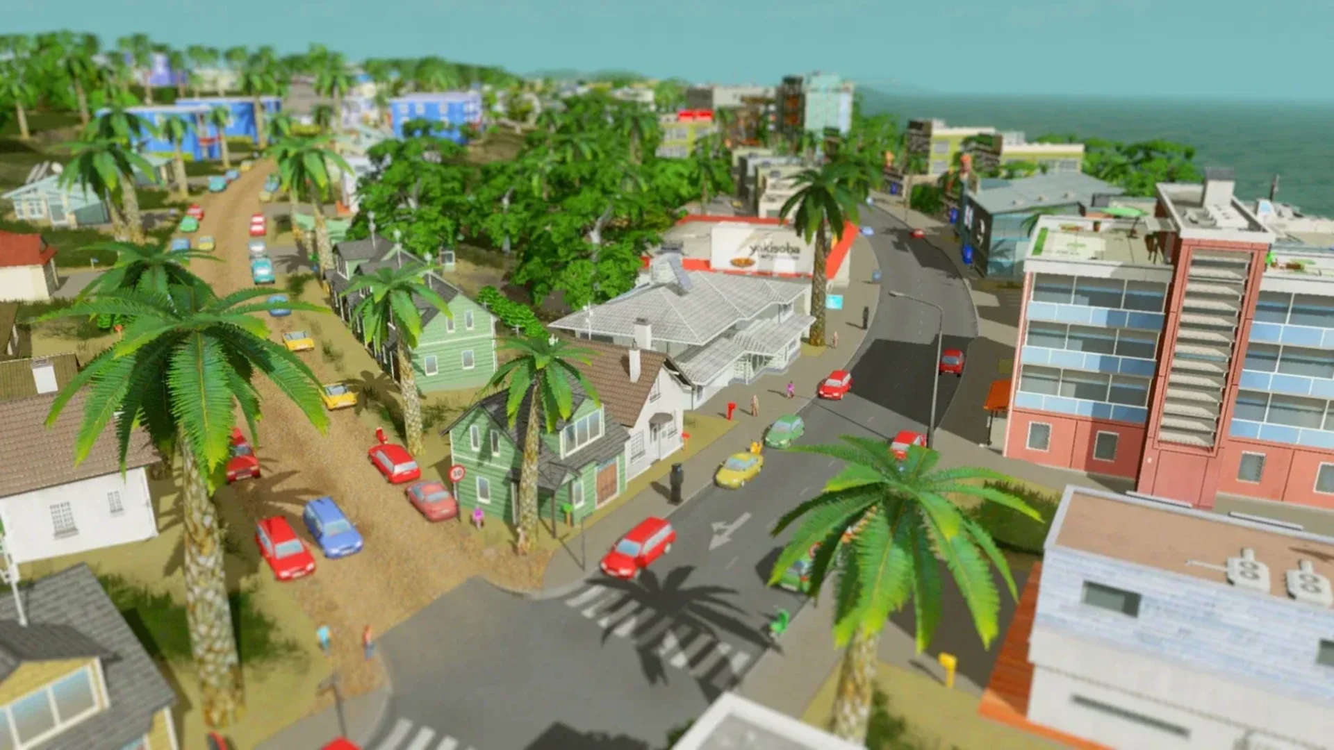 A tropical city neighborhood with homes, shops, palm trees and busy roads in Cities: Skylines.