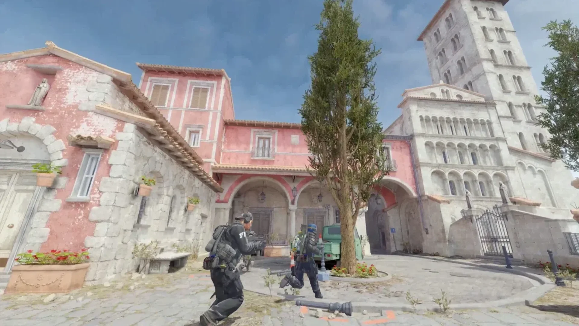 Counter-Strike 2 players move through a sunlit Mediterranean-style town near a church