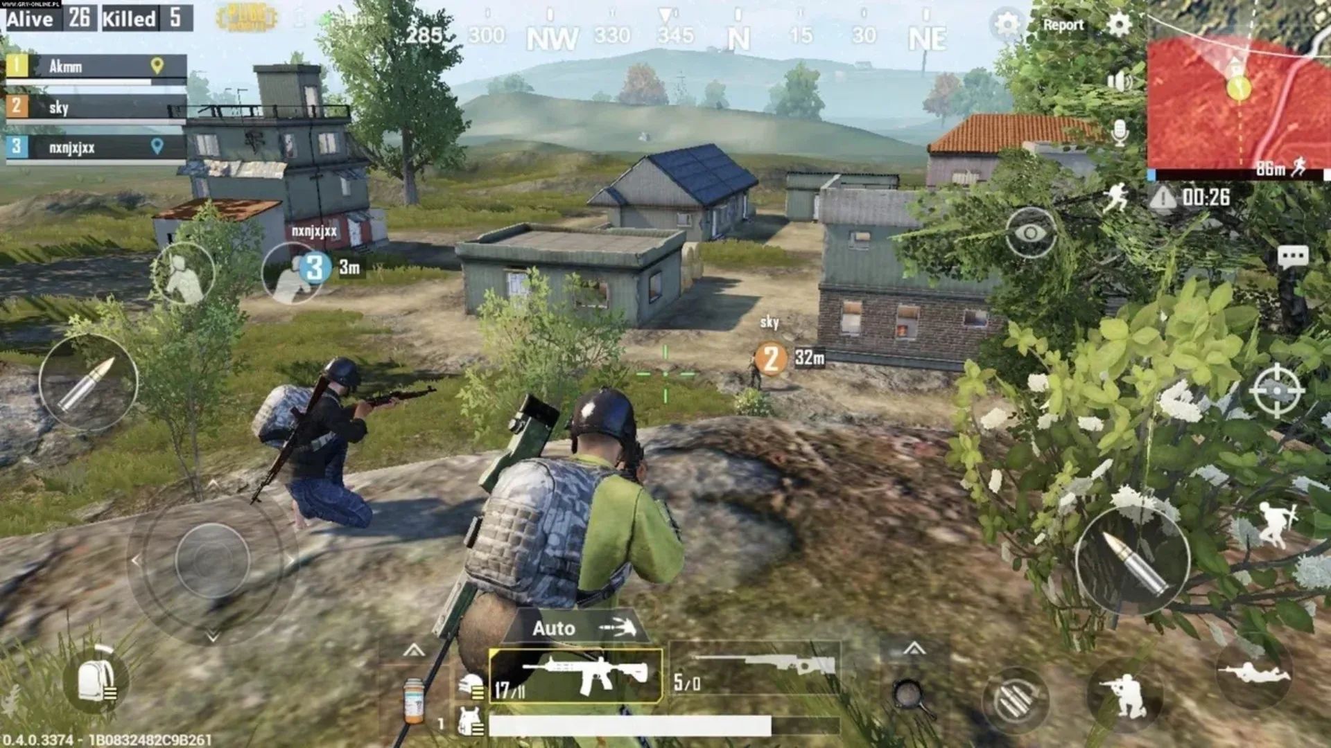 PUBG Mobile squad members aim toward buildings while positioned on a hillside above a village