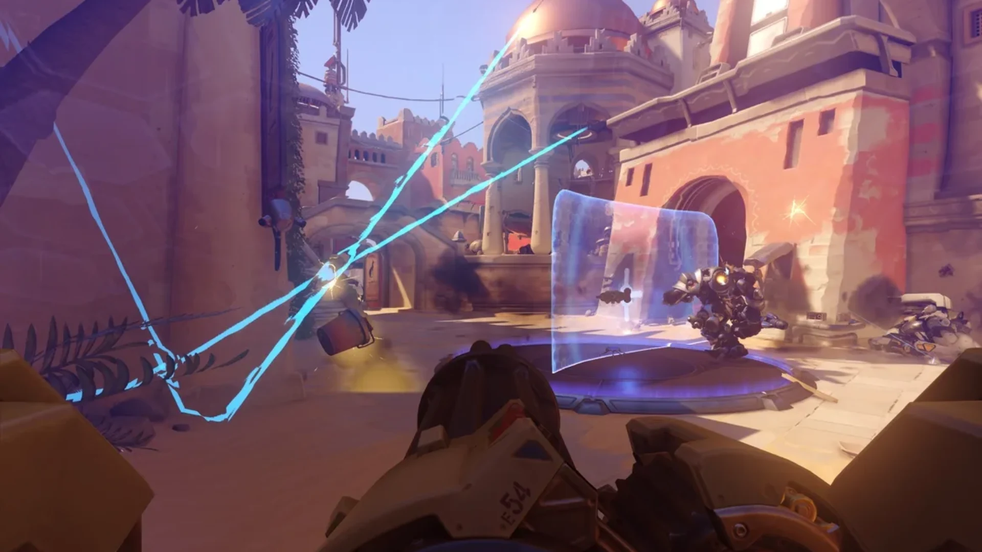 Overwatch first-person combat with Reinhardt holding a barrier during an objective fight