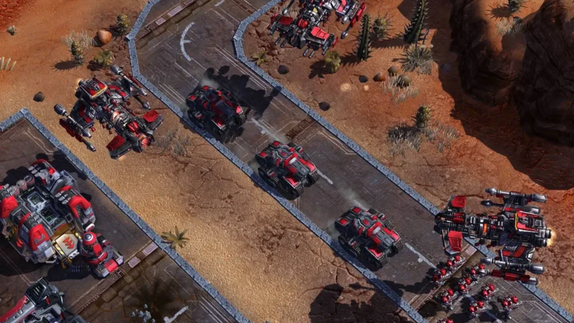 StarCraft II Terran army with armored vehicles, infantry, and military structures in a desert environment.