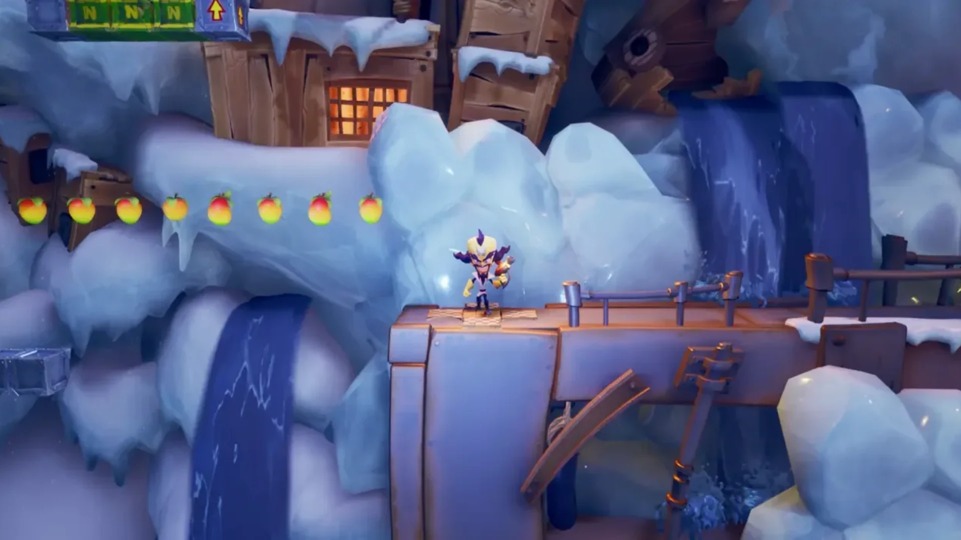 Crash Bandicoot stands on a platform in a snowy level with floating Wumpa Fruit and icy waterfalls