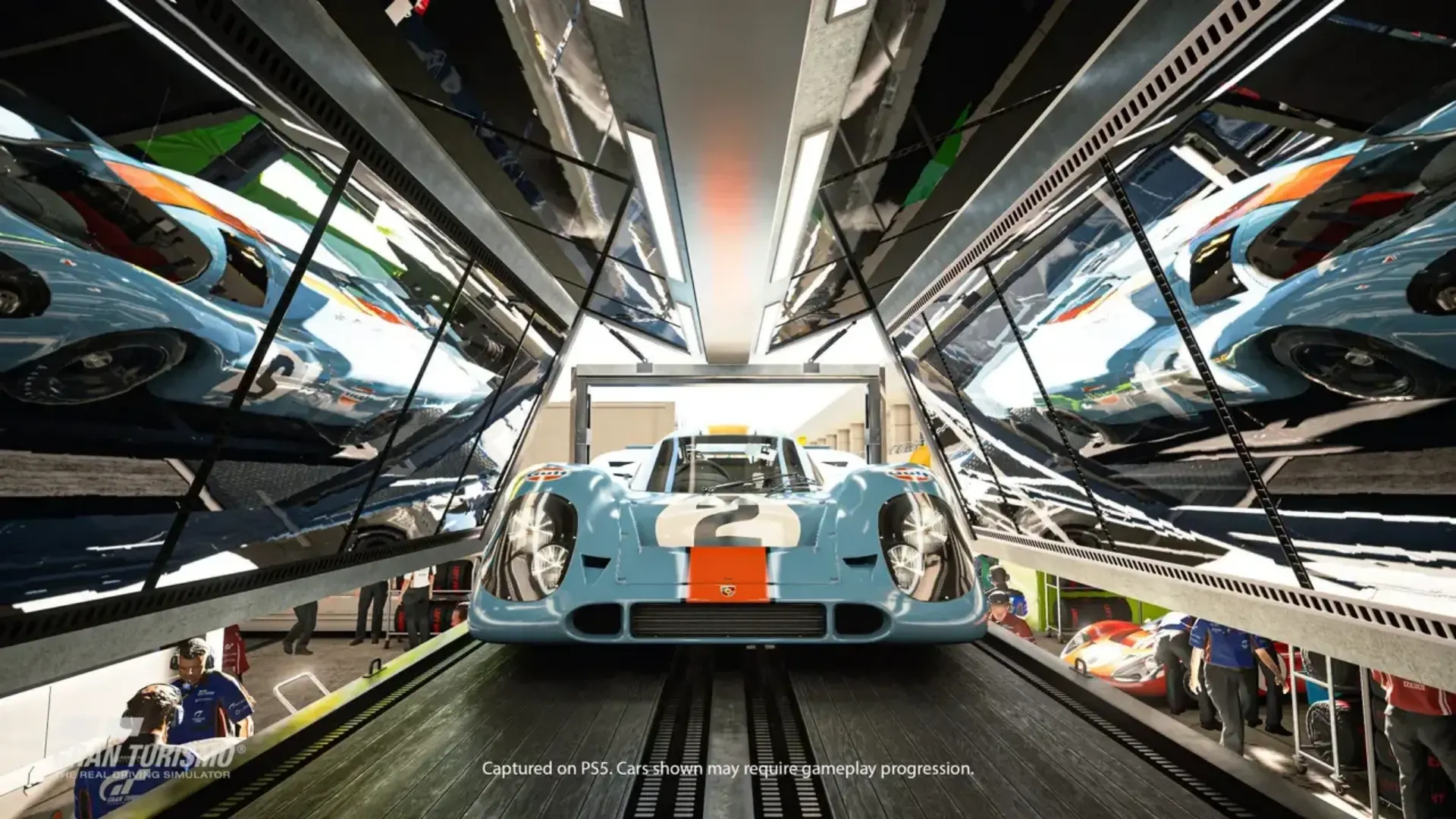 Porsche 917K race car displayed inside a transport trailer in Gran Turismo 7