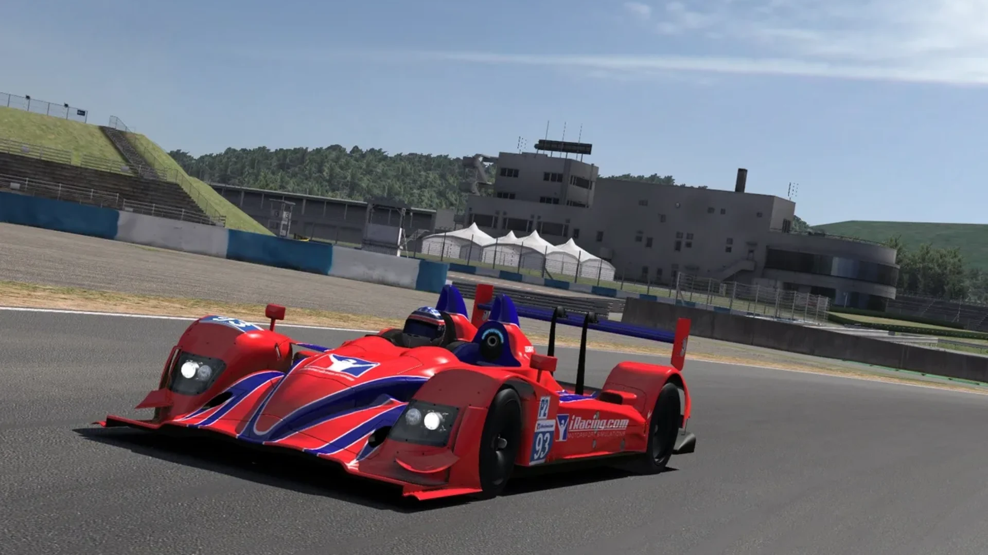 Red prototype race car driving around a circuit in iRacing