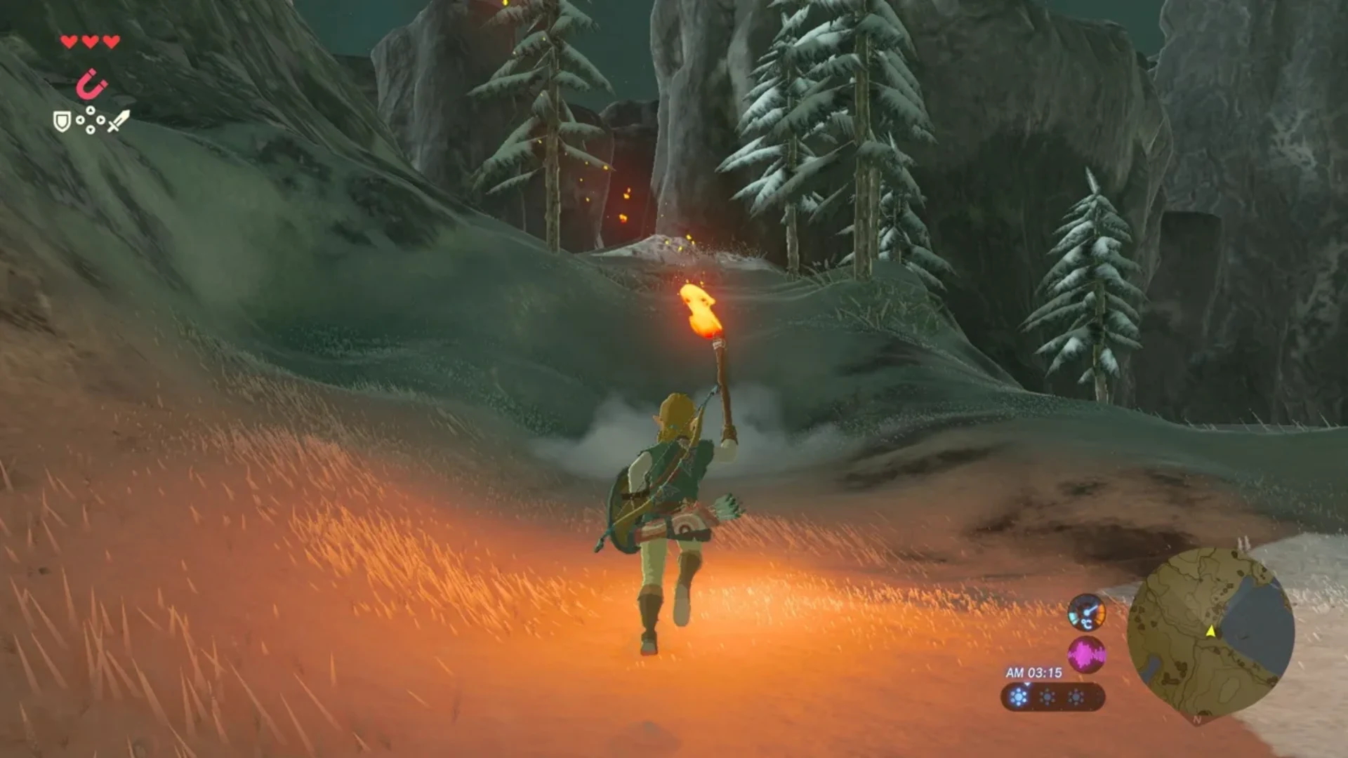 Link carries a torch while exploring a snowy mountain at night in Breath of the Wild.