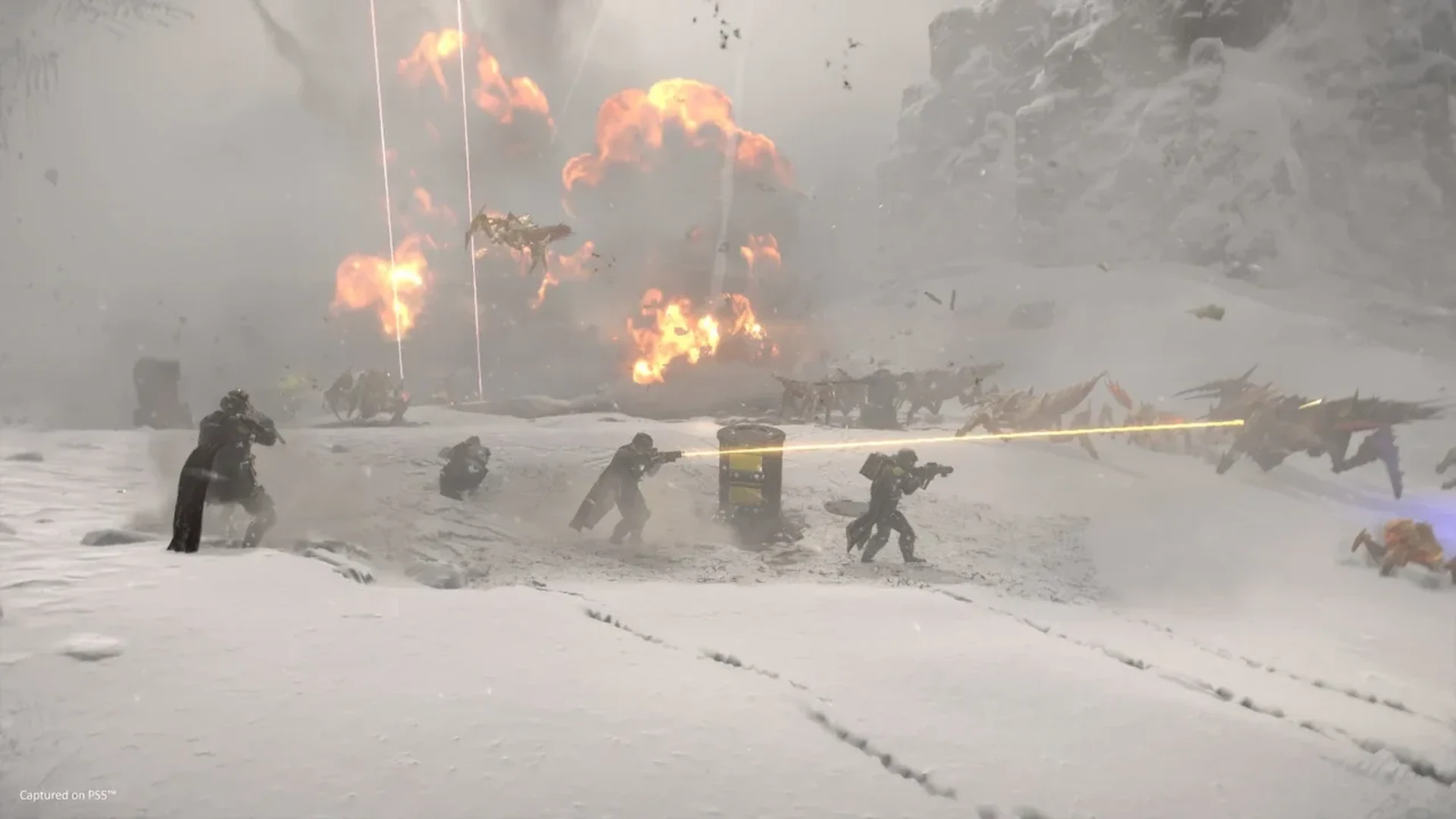 Helldivers 2 squad firing weapons during a battle on a snowy planet