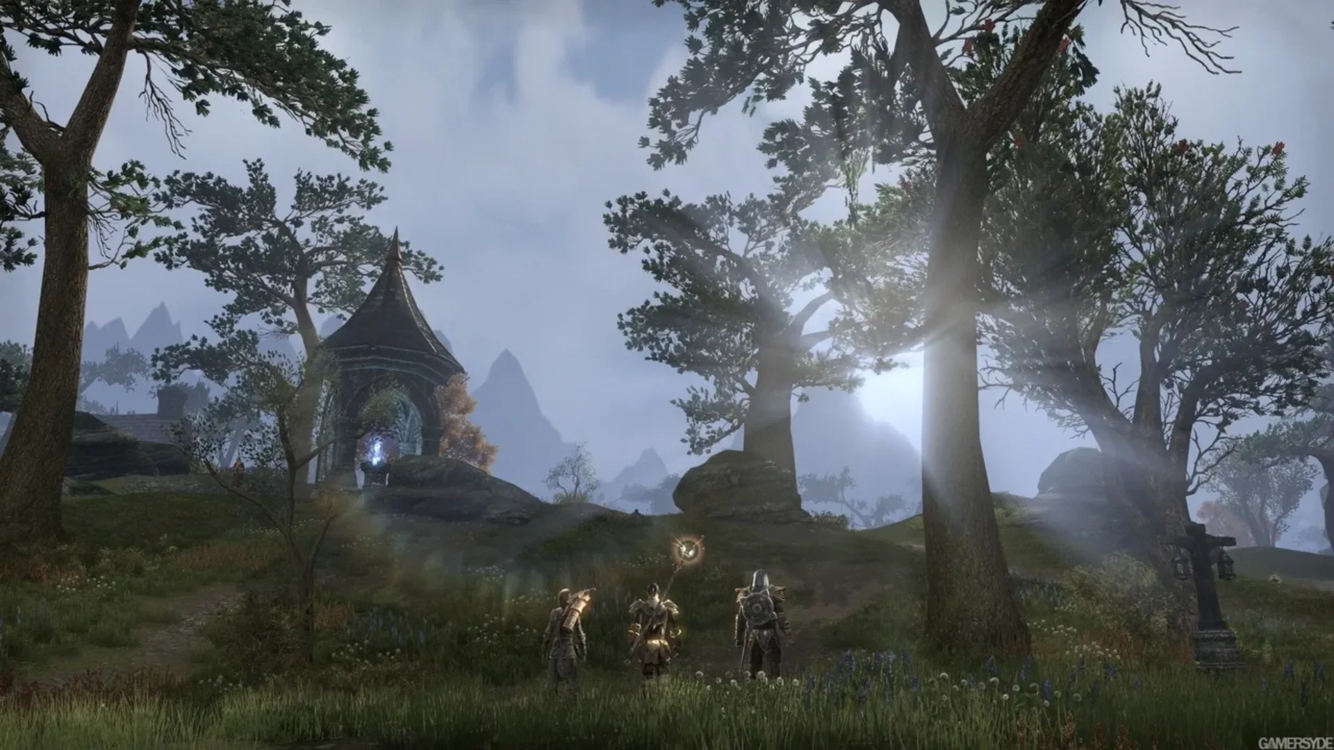 The Elder Scrolls Online adventurers exploring a misty forest near an ancient stone structure