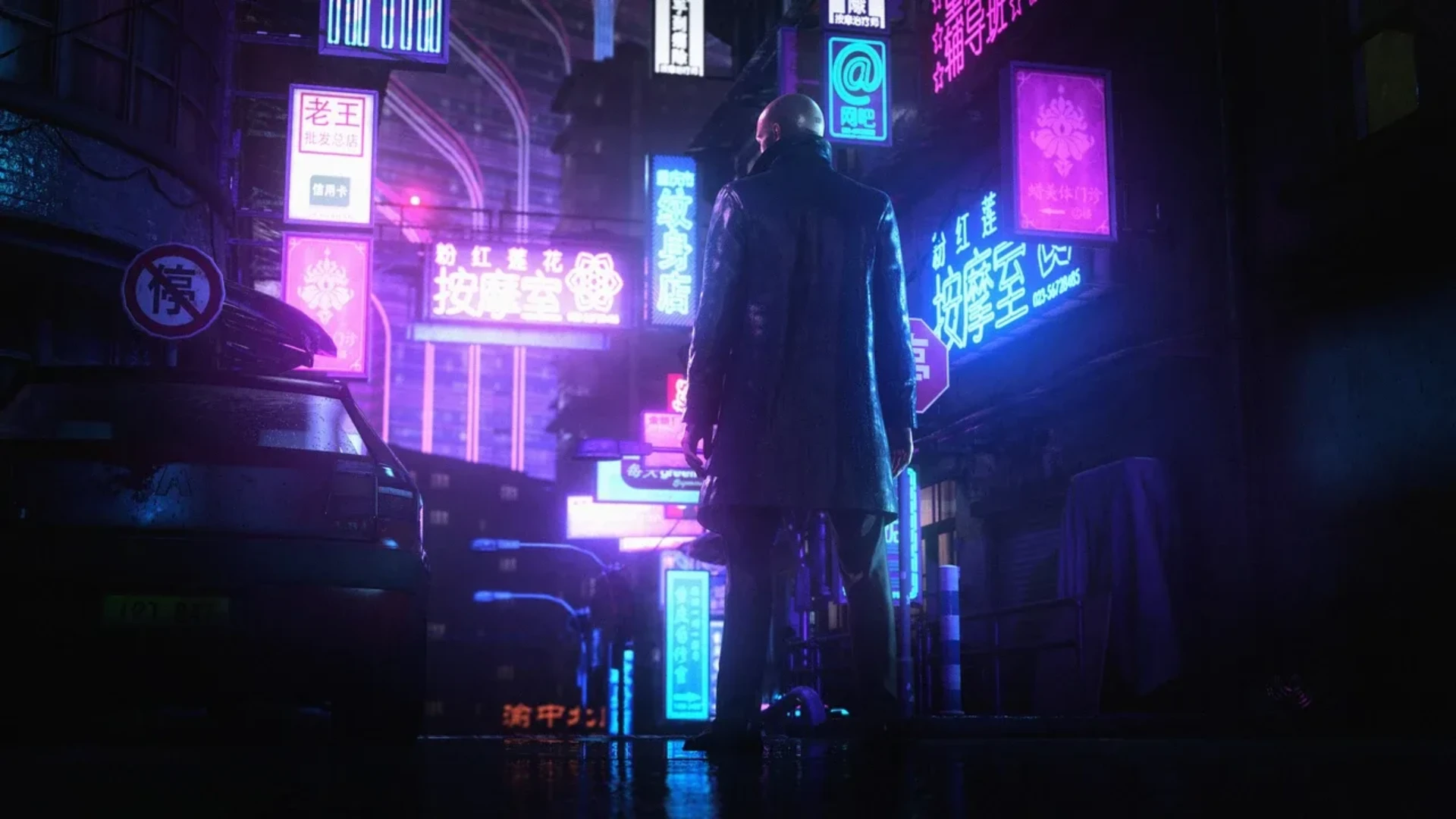 Agent 47 walks through a neon-lit city street in Hitman World of Assassination