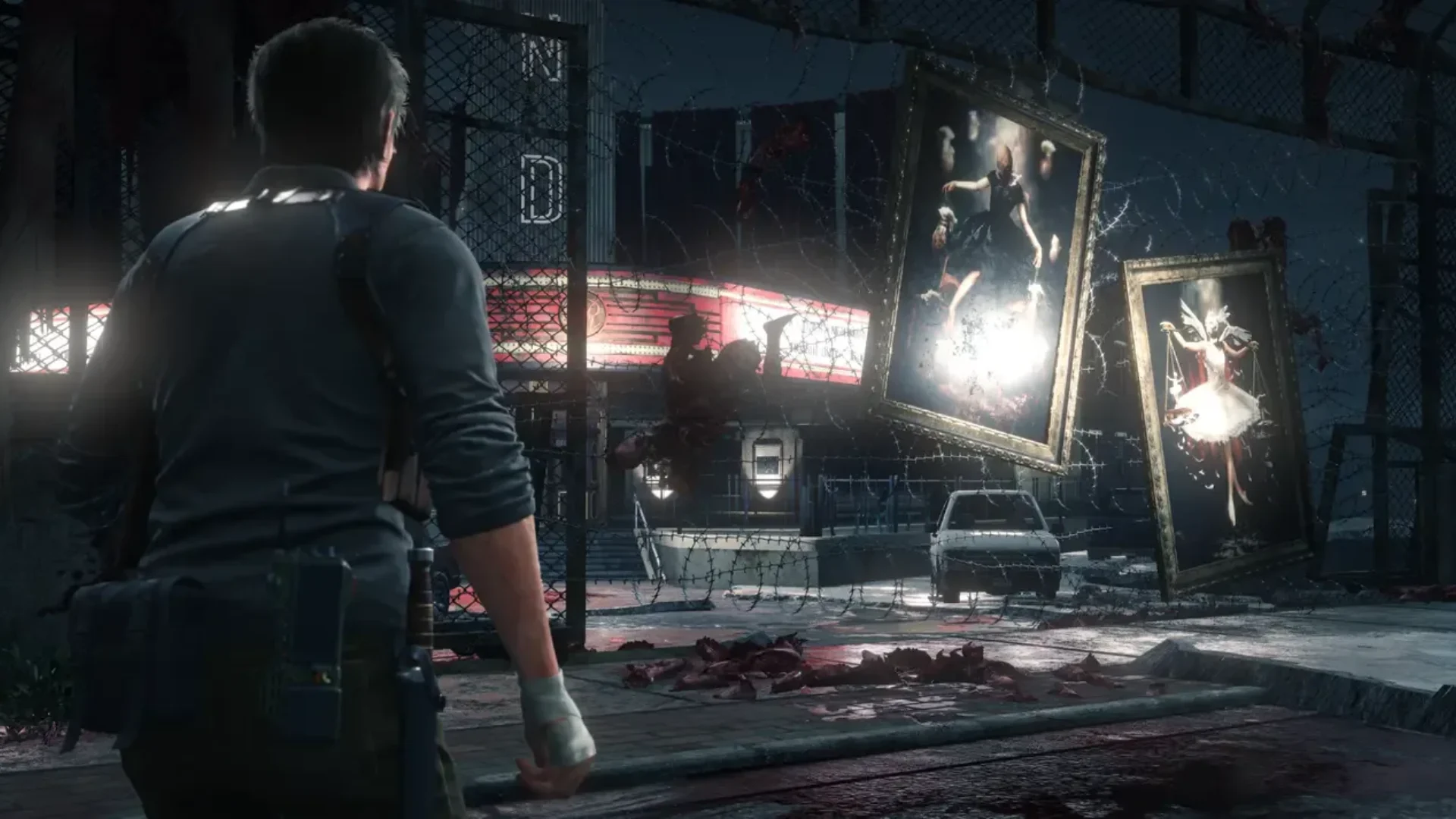 Sebastian Castellanos approaches a fenced area with disturbing artwork and remains in The Evil Within 2.