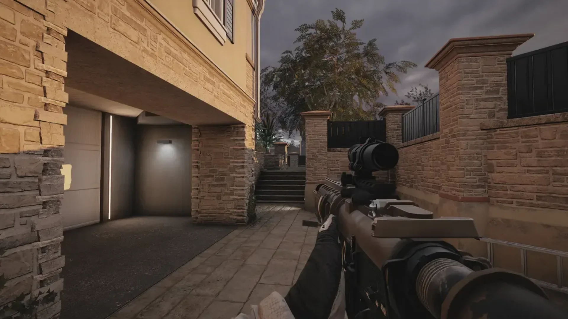 A Rainbow Six Siege operator aims a scoped rifle through a narrow outdoor passage beside a building.