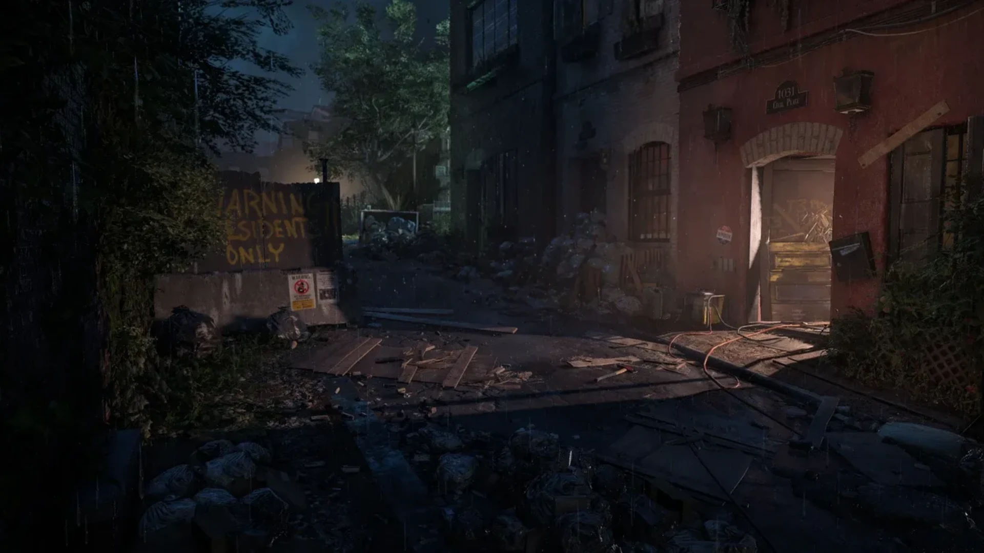A dark rain-soaked urban alley filled with debris and abandoned buildings in The Division 2.
