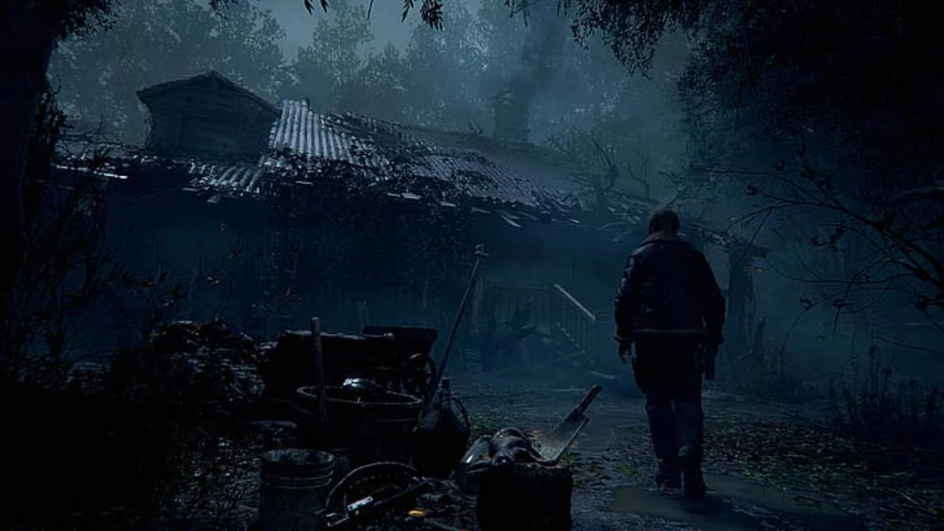 Leon Kennedy approaches a dark village at night in Resident Evil 4 Remake