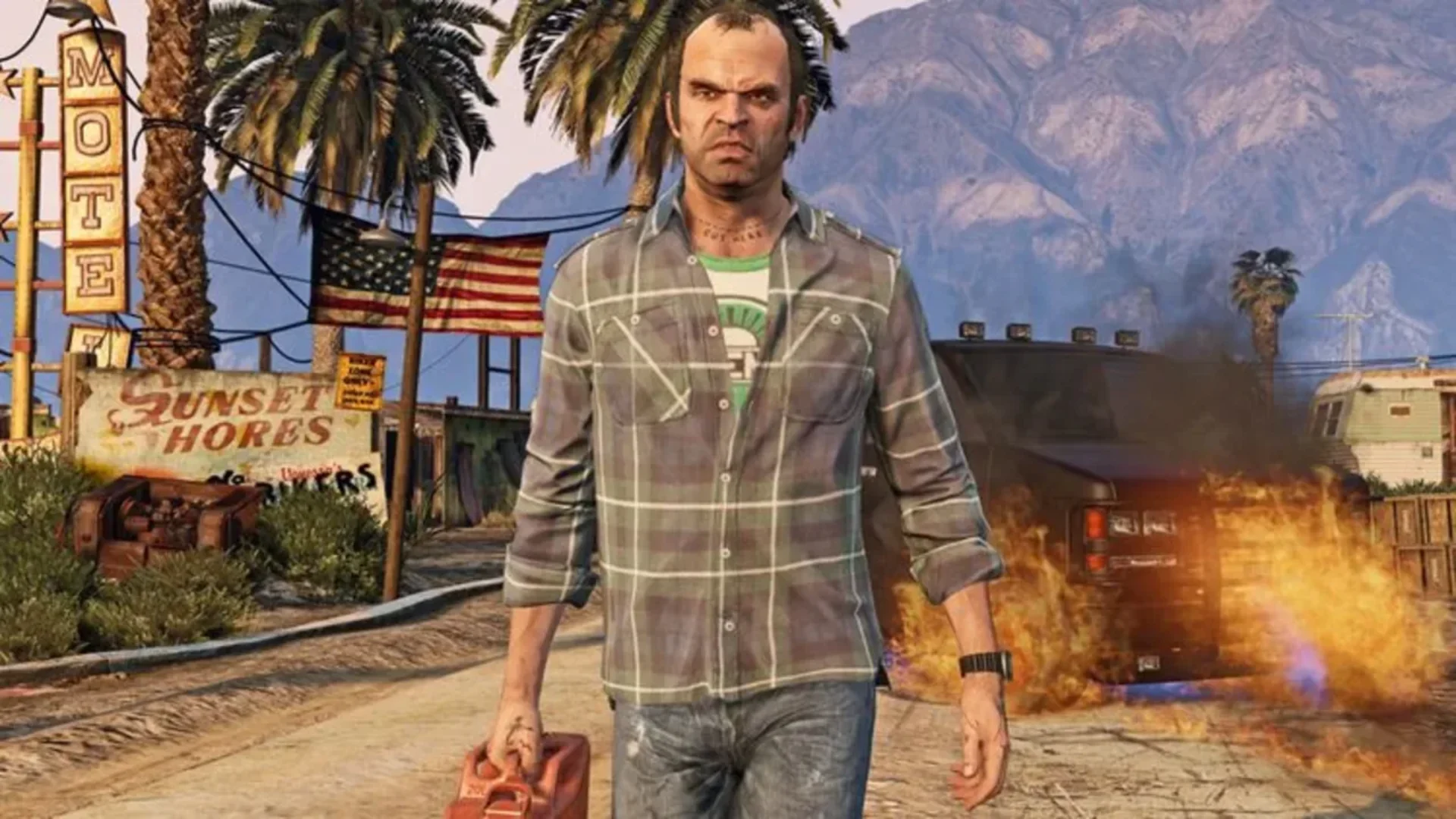 Trevor Phillips standing near a burning vehicle in Grand Theft Auto V