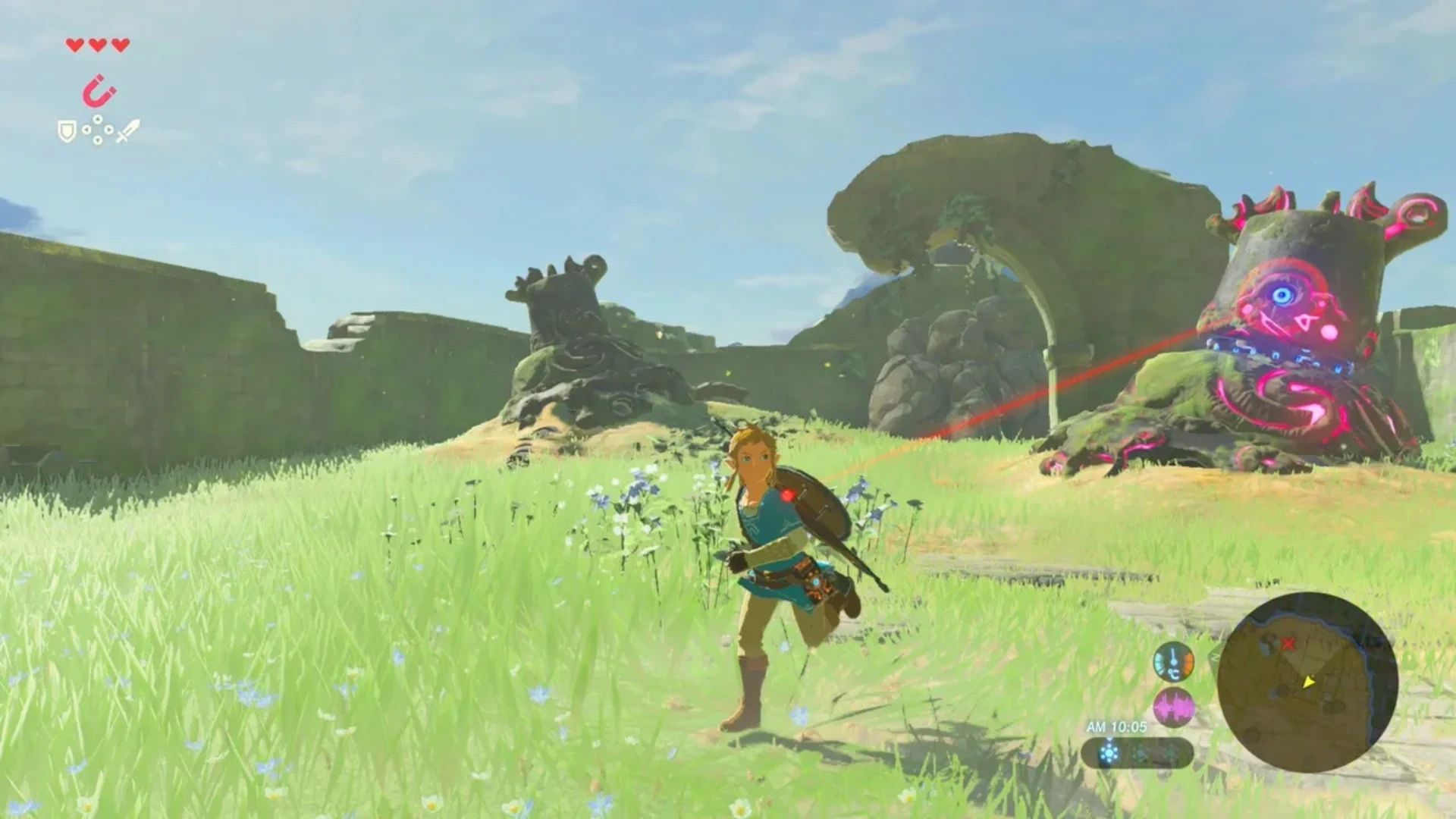 Link running through grass as a Guardian targets him in Breath of the Wild