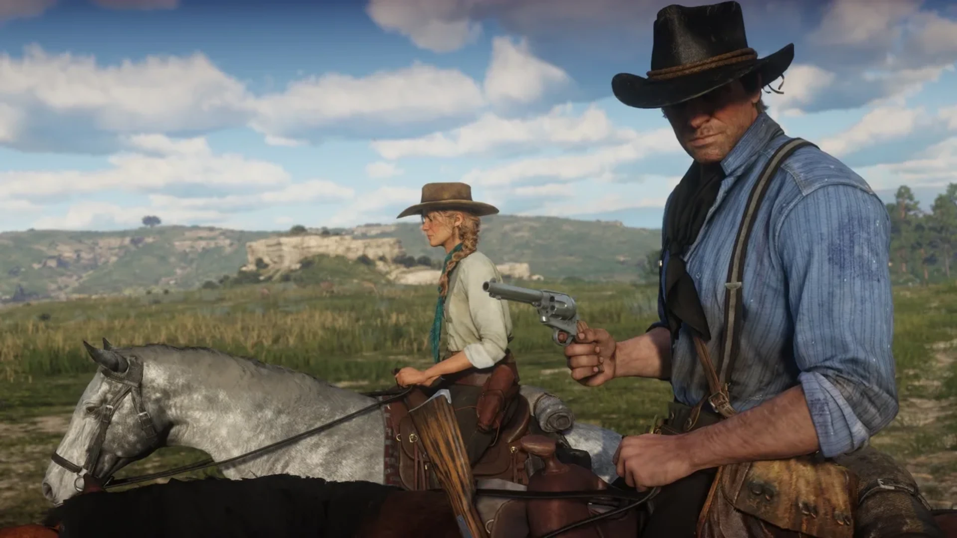 Arthur Morgan holds a revolver while riding beside another outlaw in Red Dead Redemption 2