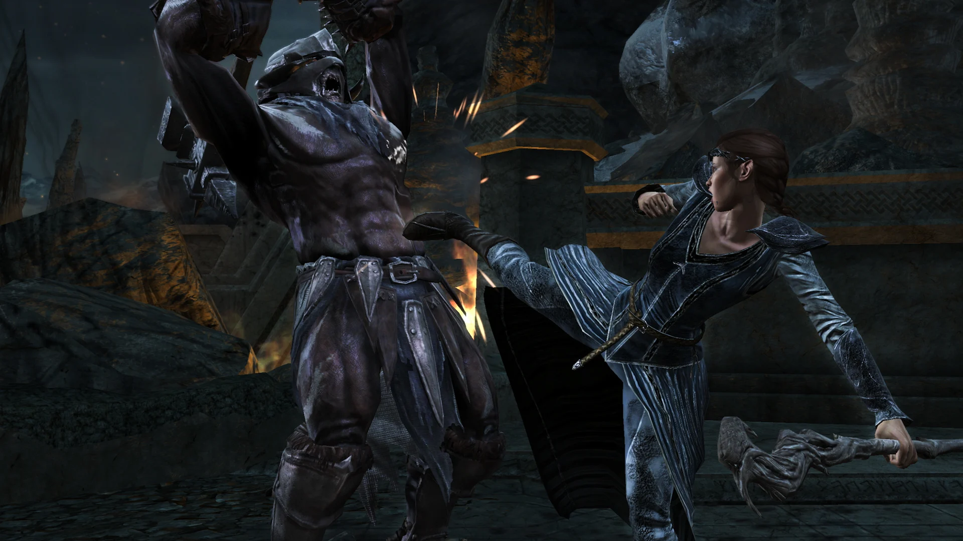 Elven Loremaster Andriel kicks an Orc during combat in The Lord of the Rings: War in the North